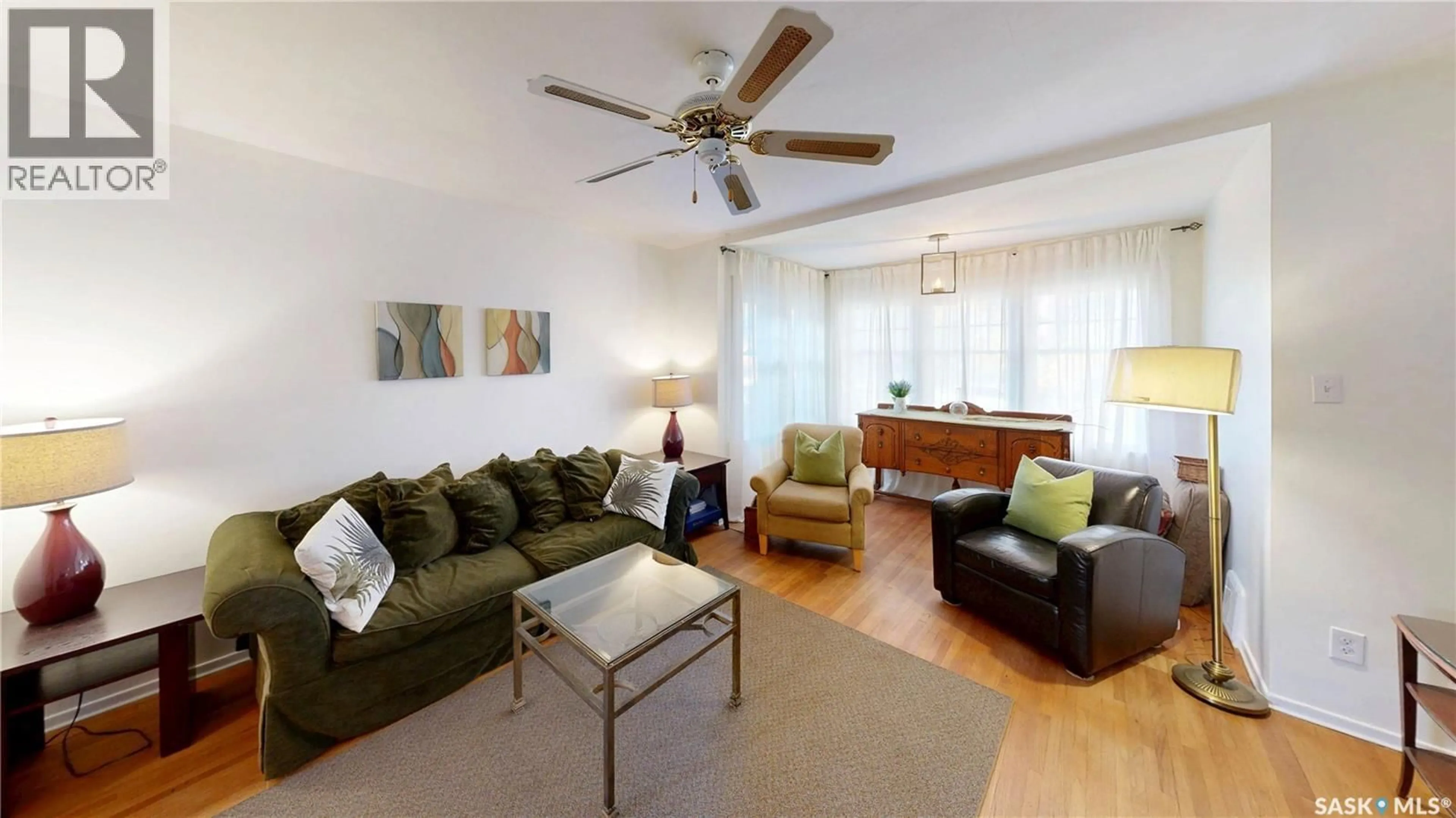 Living room with furniture, wood/laminate floor for 3723 VICTORIA AVENUE, Regina Saskatchewan S4T1M5