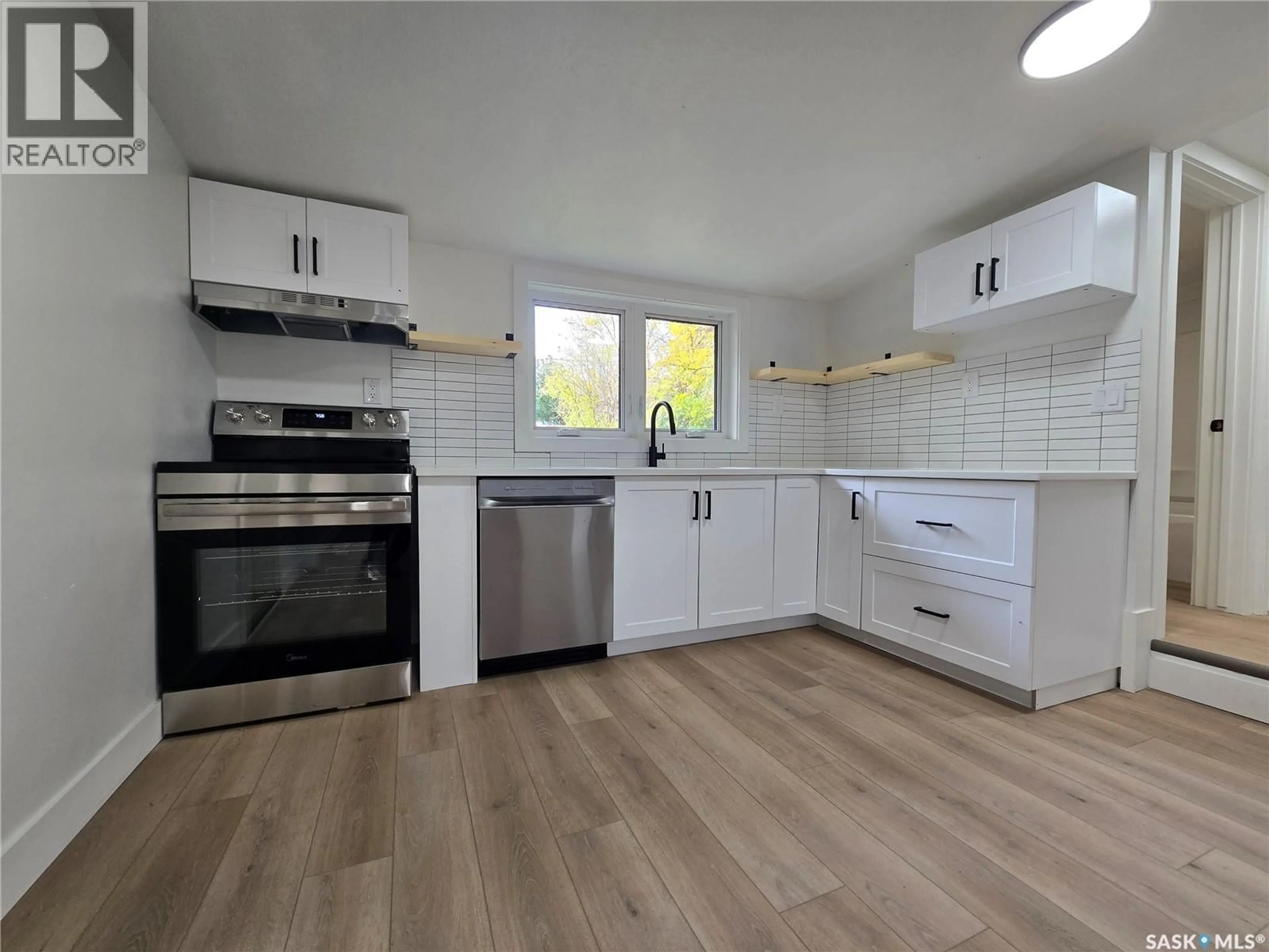 Open concept kitchen, wood/laminate floor for 330 3RD AVENUE, Weyburn Saskatchewan S4H1X4
