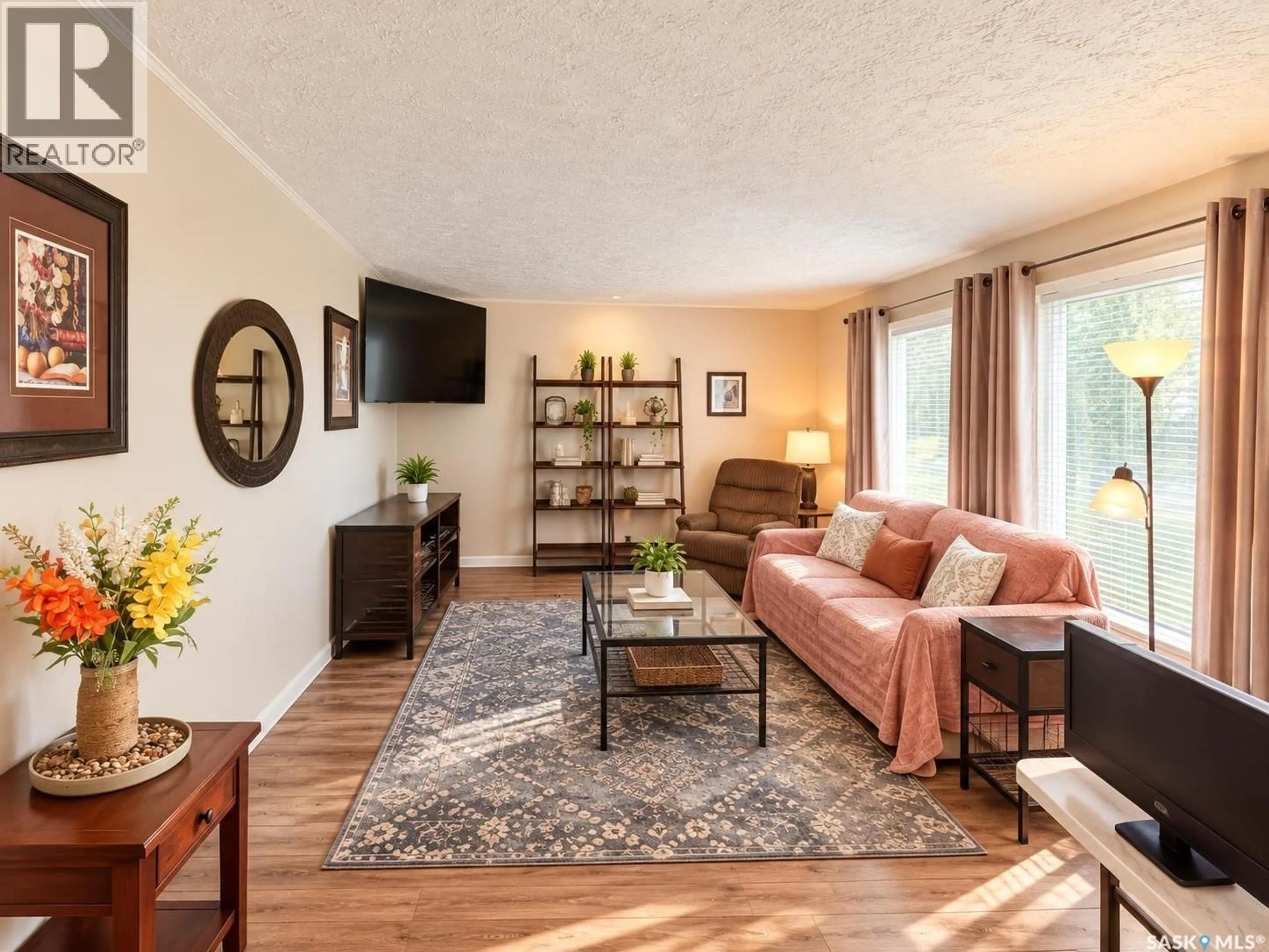 Living room with furniture, wood/laminate floor for 601 2ND AVENUE, Raymore Saskatchewan S0A3J0