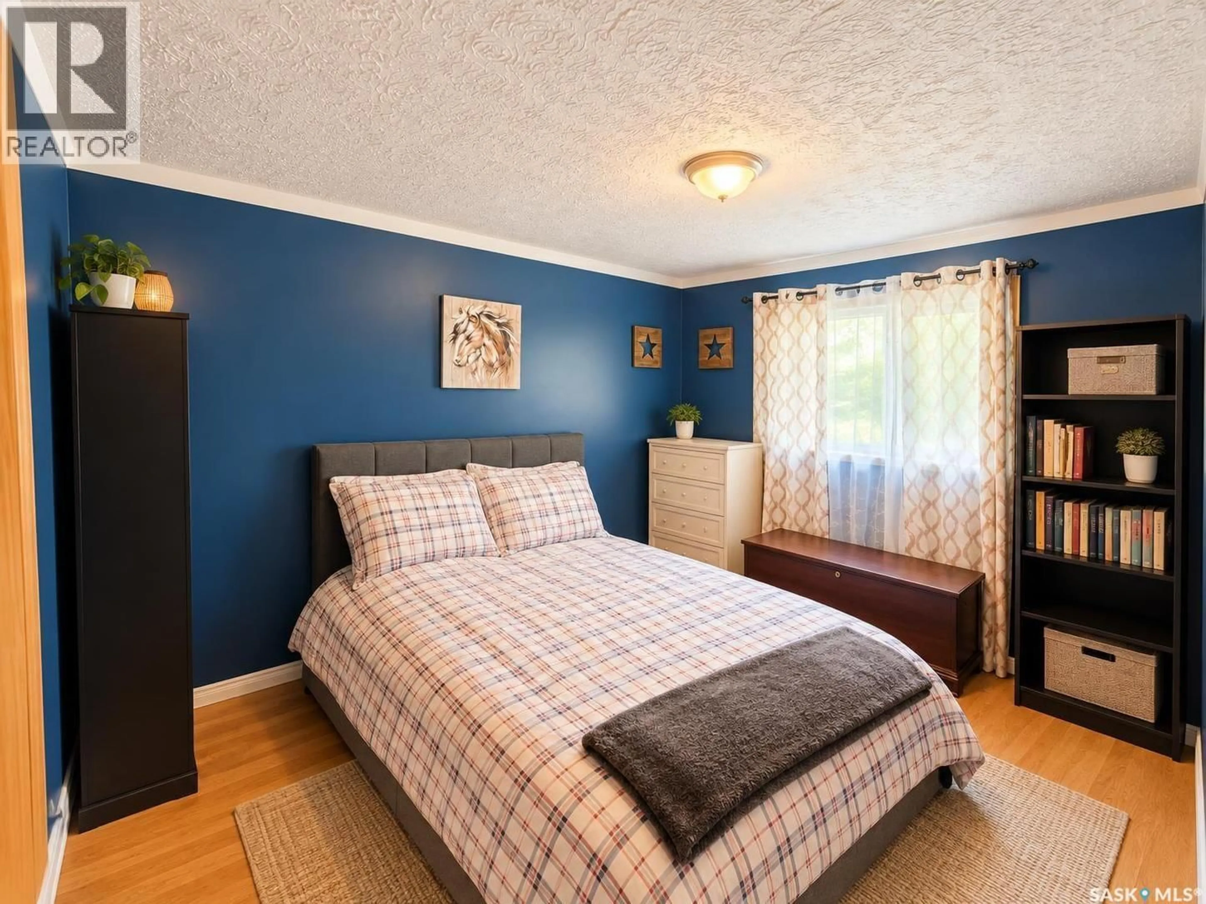 Bedroom with bed, wood/laminate floor for 601 2ND AVENUE, Raymore Saskatchewan S0A3J0