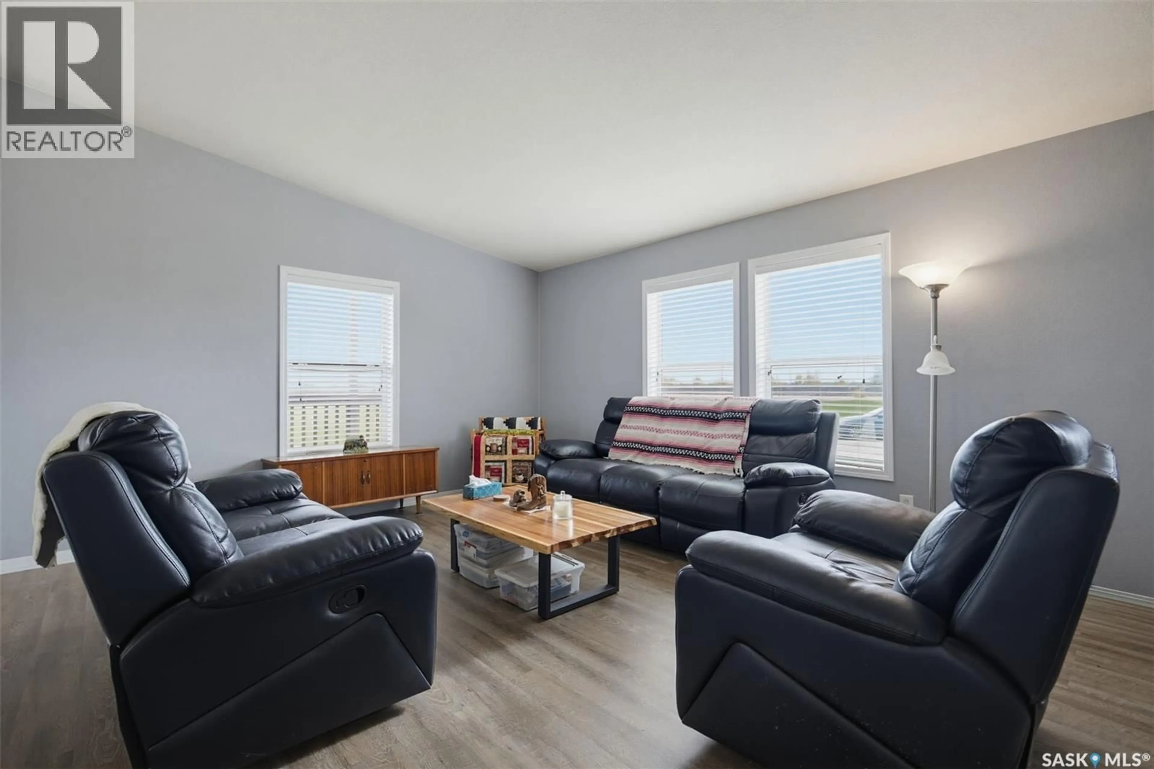 Living room with furniture, wood/laminate floor for 13 401 RAILWAY AVENUE, Vanscoy Saskatchewan S0L3J0
