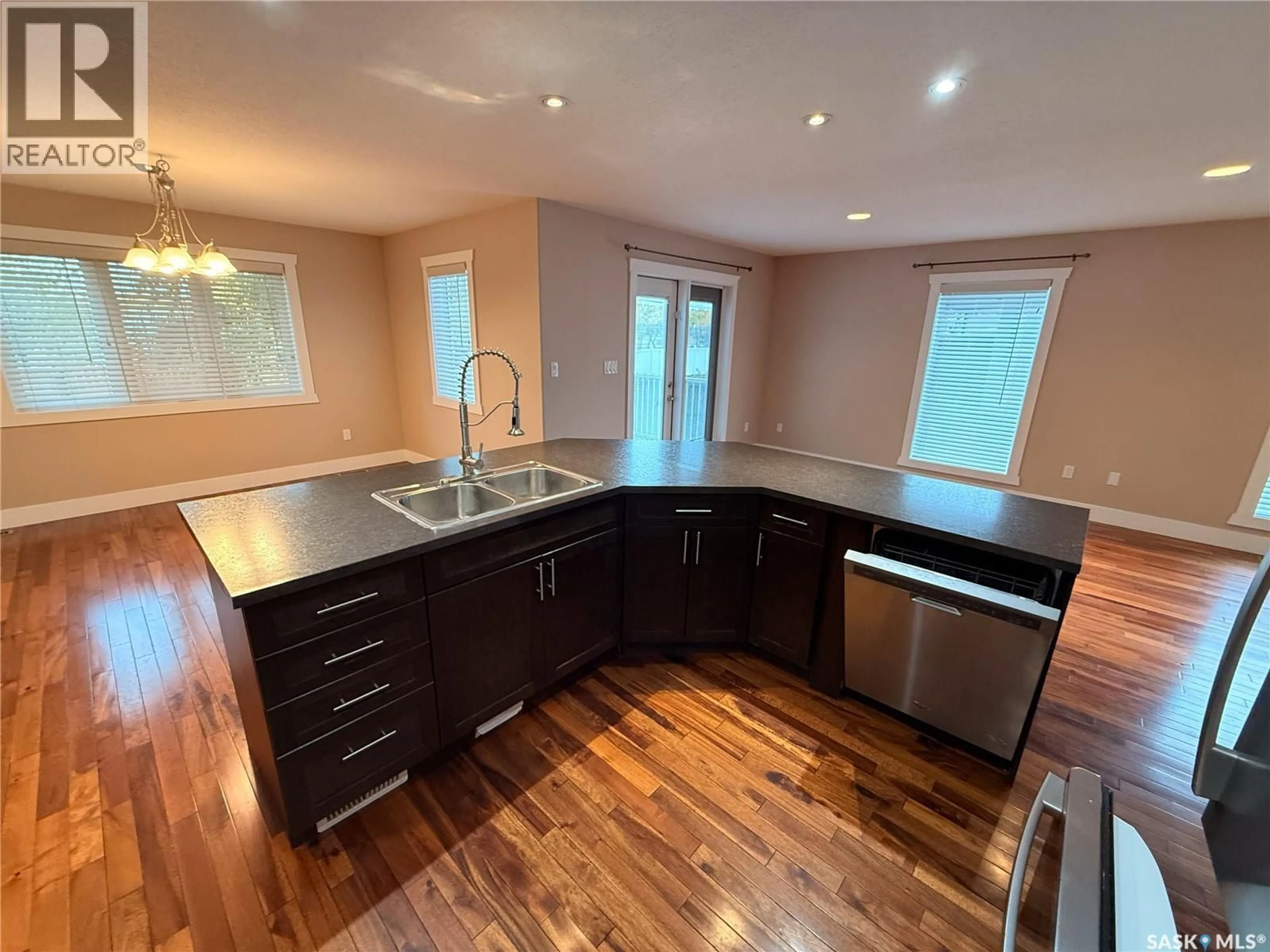 Open concept kitchen, wood/laminate floor for 725 CENTRE STREET, Shaunavon Saskatchewan S0N2M0