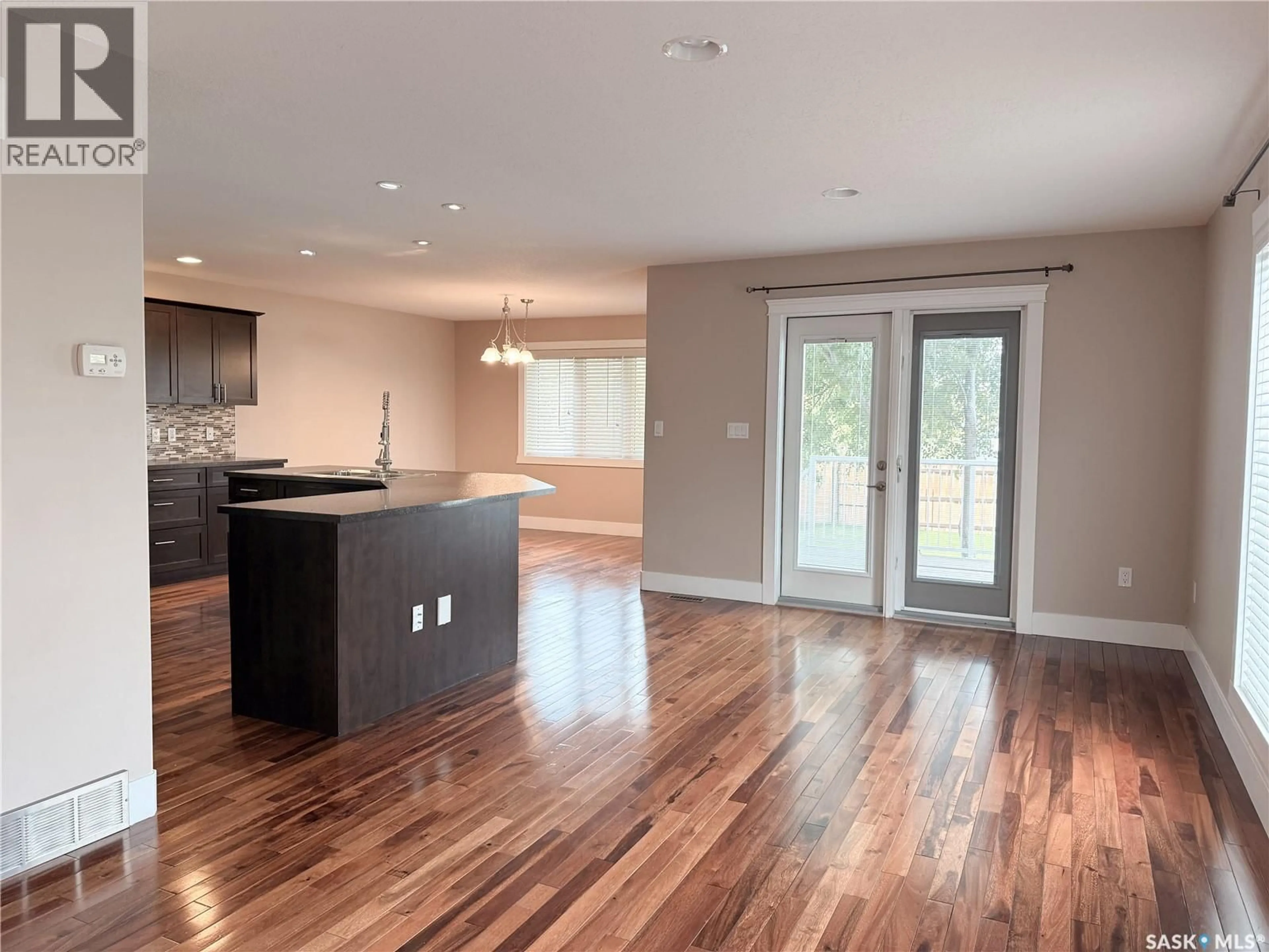Open concept kitchen, wood/laminate floor for 725 CENTRE STREET, Shaunavon Saskatchewan S0N2M0