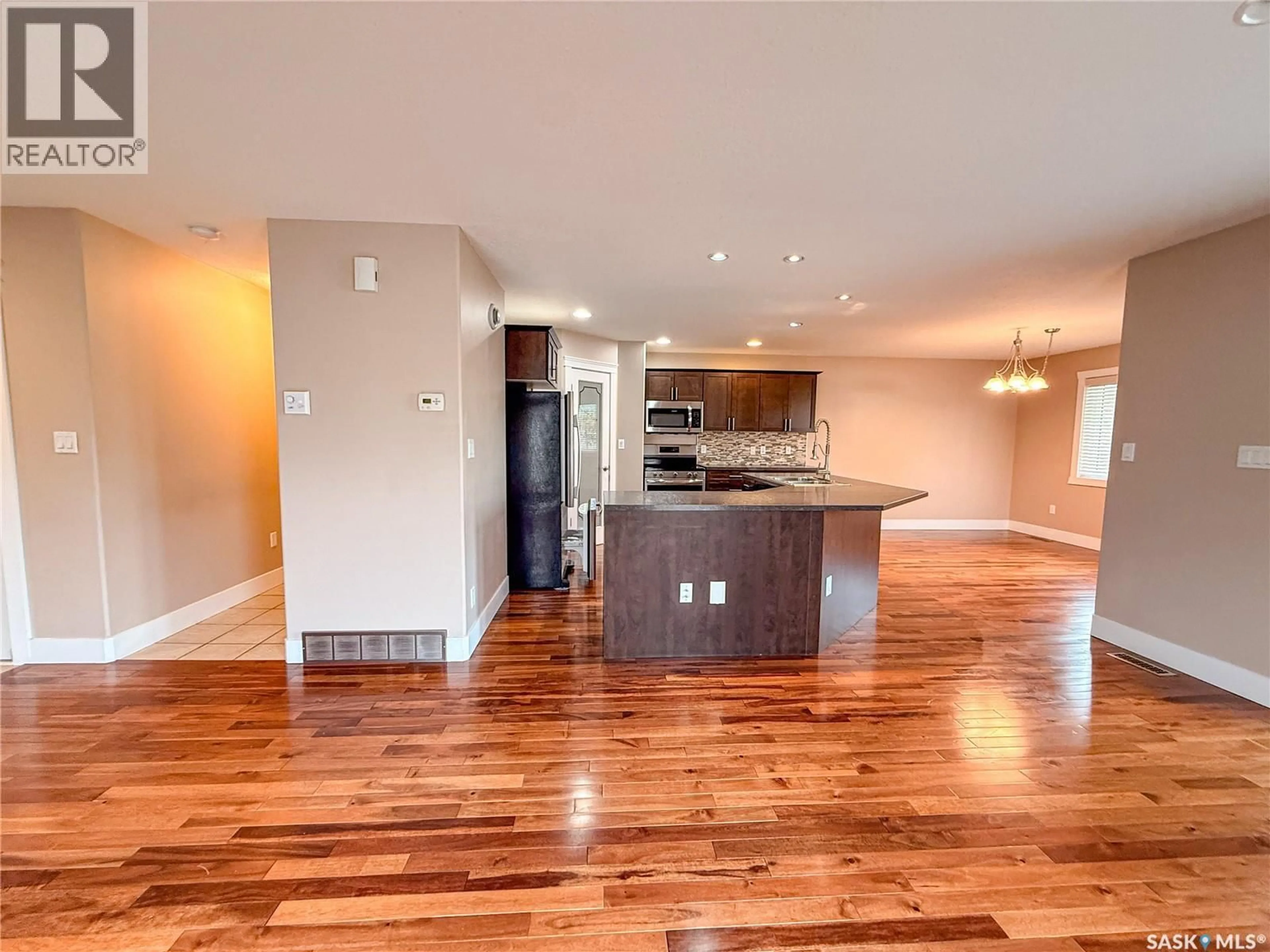Open concept kitchen, wood/laminate floor for 725 CENTRE STREET, Shaunavon Saskatchewan S0N2M0