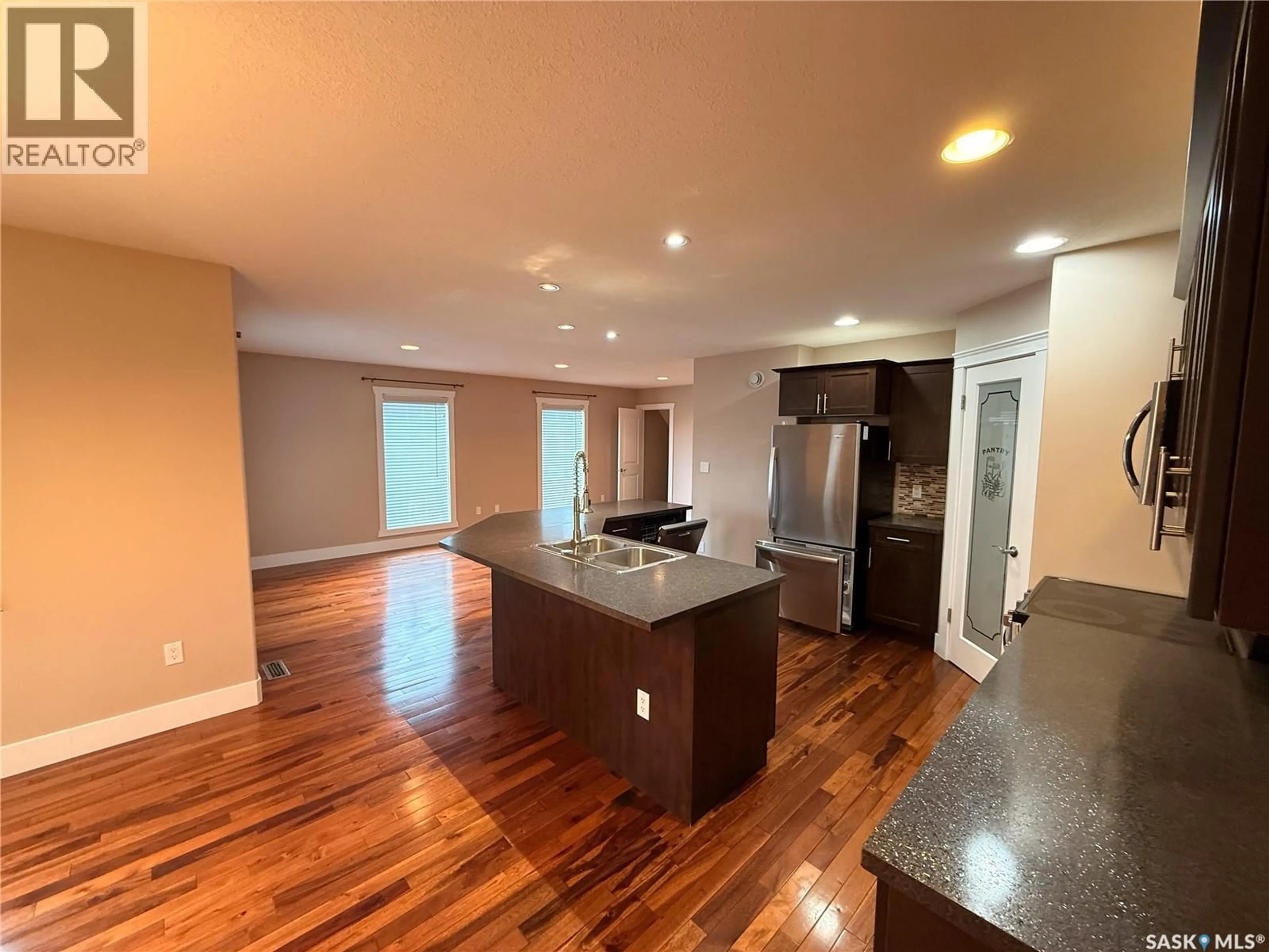 Open concept kitchen, wood/laminate floor for 725 CENTRE STREET, Shaunavon Saskatchewan S0N2M0