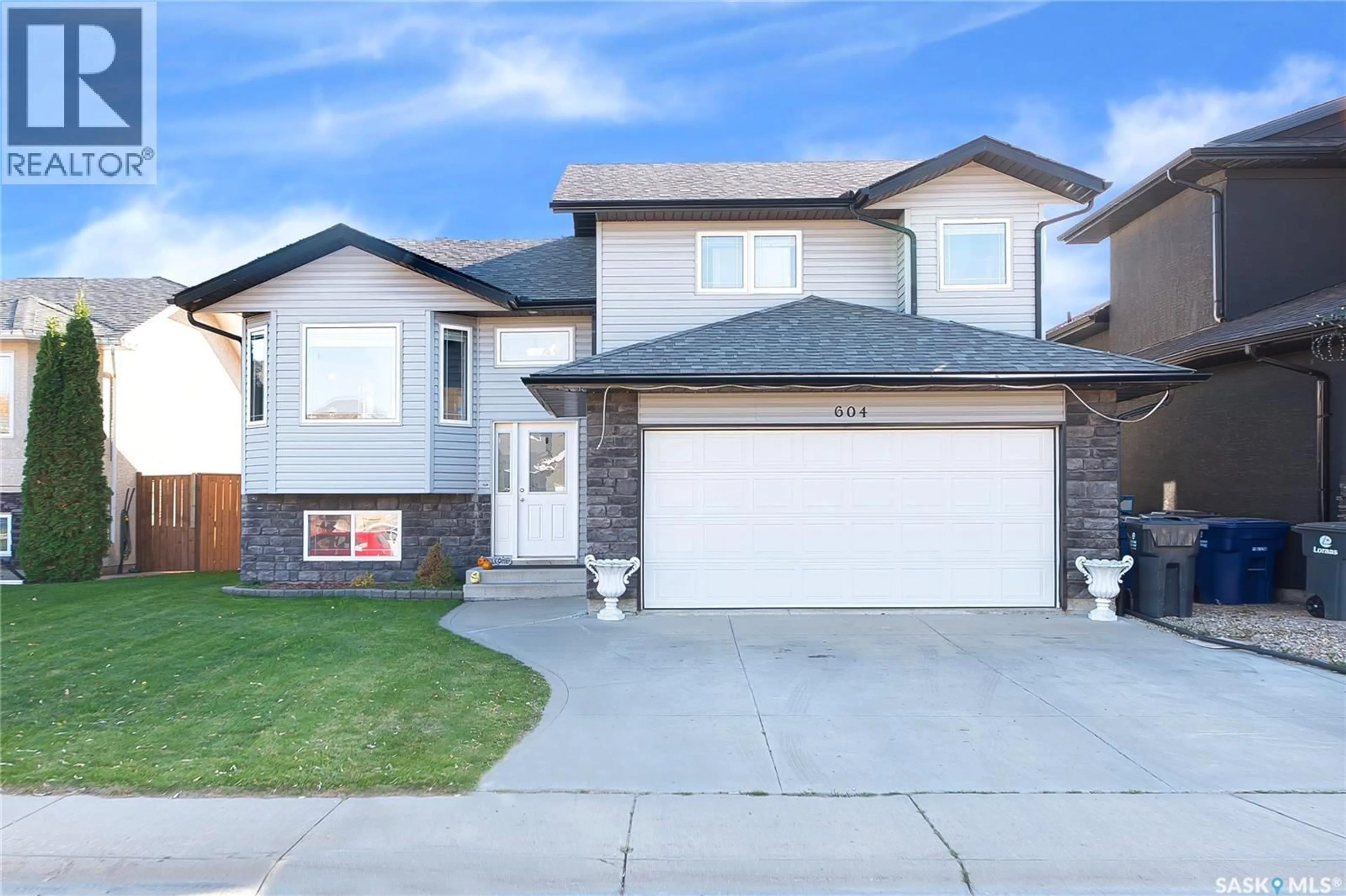 Home with vinyl exterior material, street for 604 REGIER PLACE, Martensville Saskatchewan S0K0A2