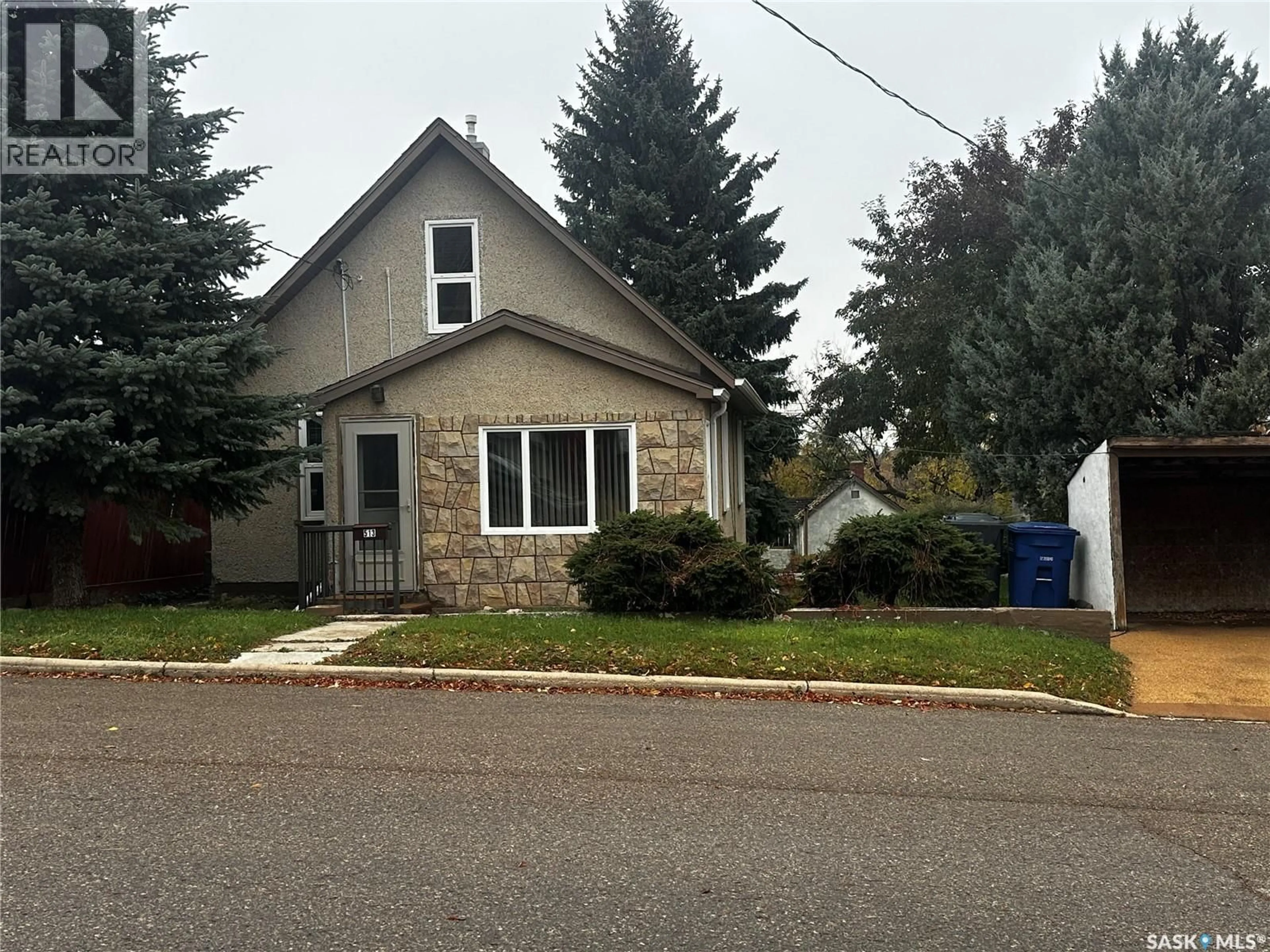 Home with vinyl exterior material, street for 513 5TH AVENUE, Weyburn Saskatchewan S4H1Y7