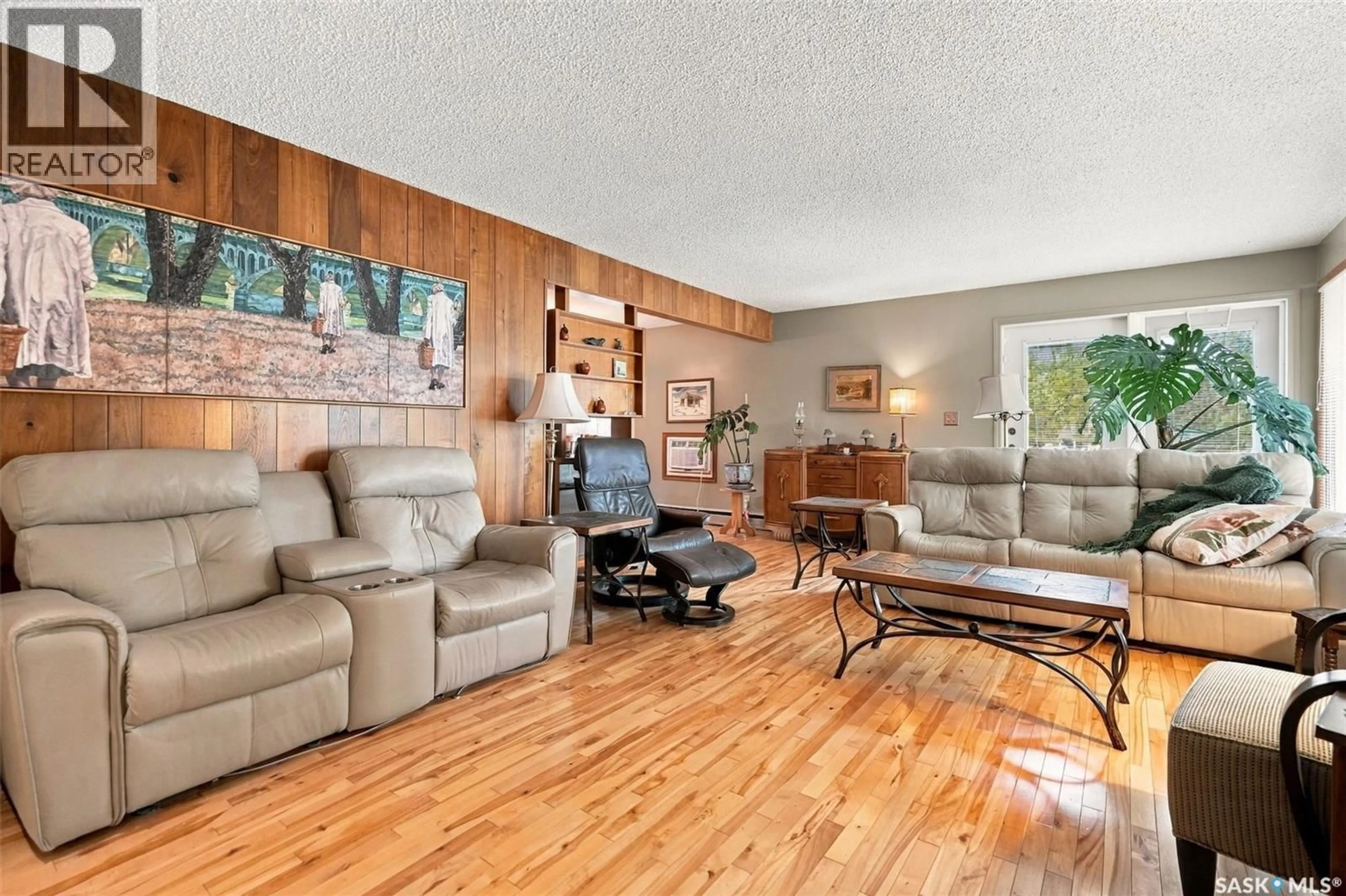 Living room with furniture, wood/laminate floor for 4002 ELPHINSTONE STREET, Regina Saskatchewan S4S3K9