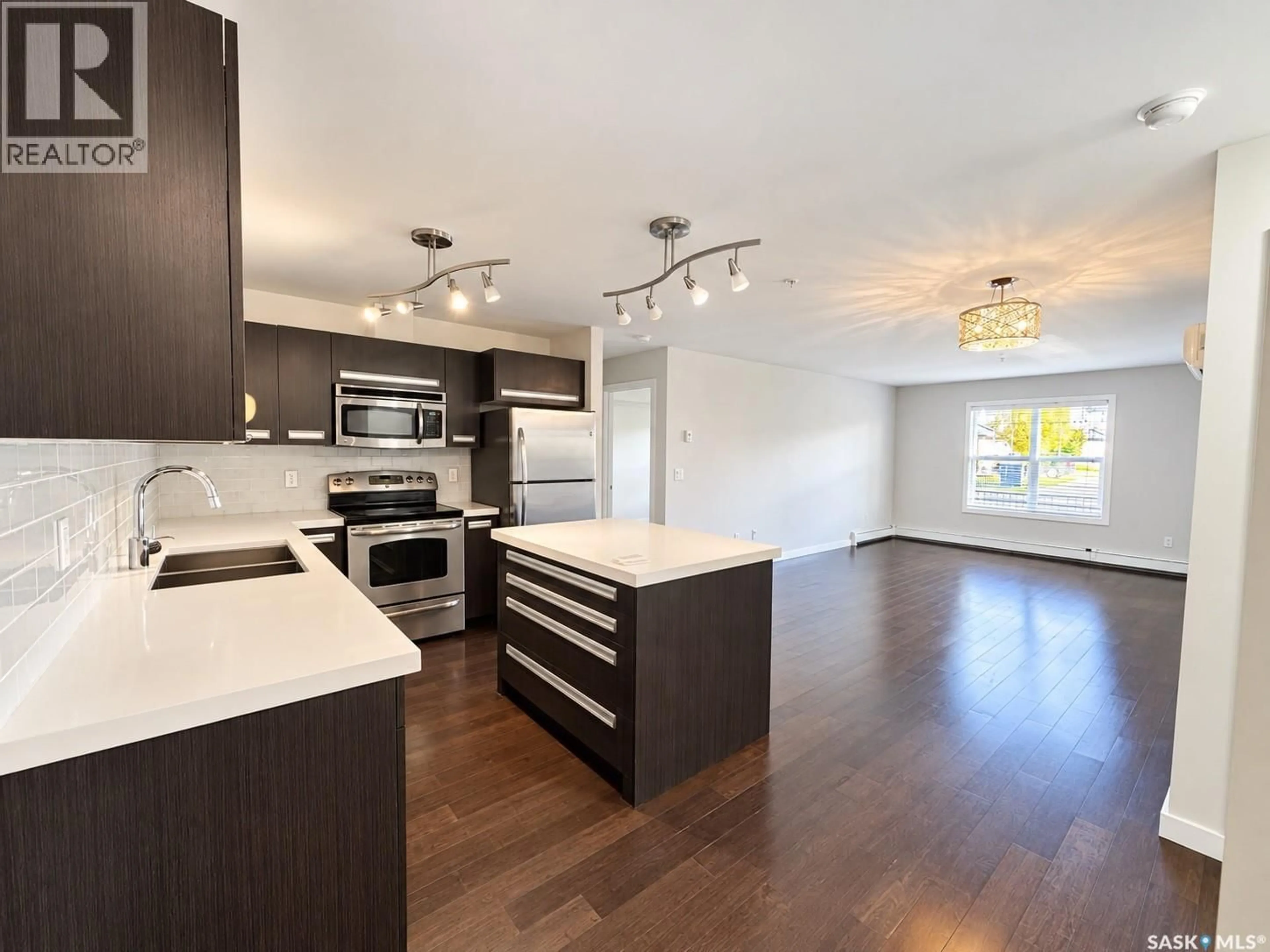Open concept kitchen, wood/laminate floor for 211 - 105 LEDINGHAM STREET, Saskatoon Saskatchewan S7V0C5