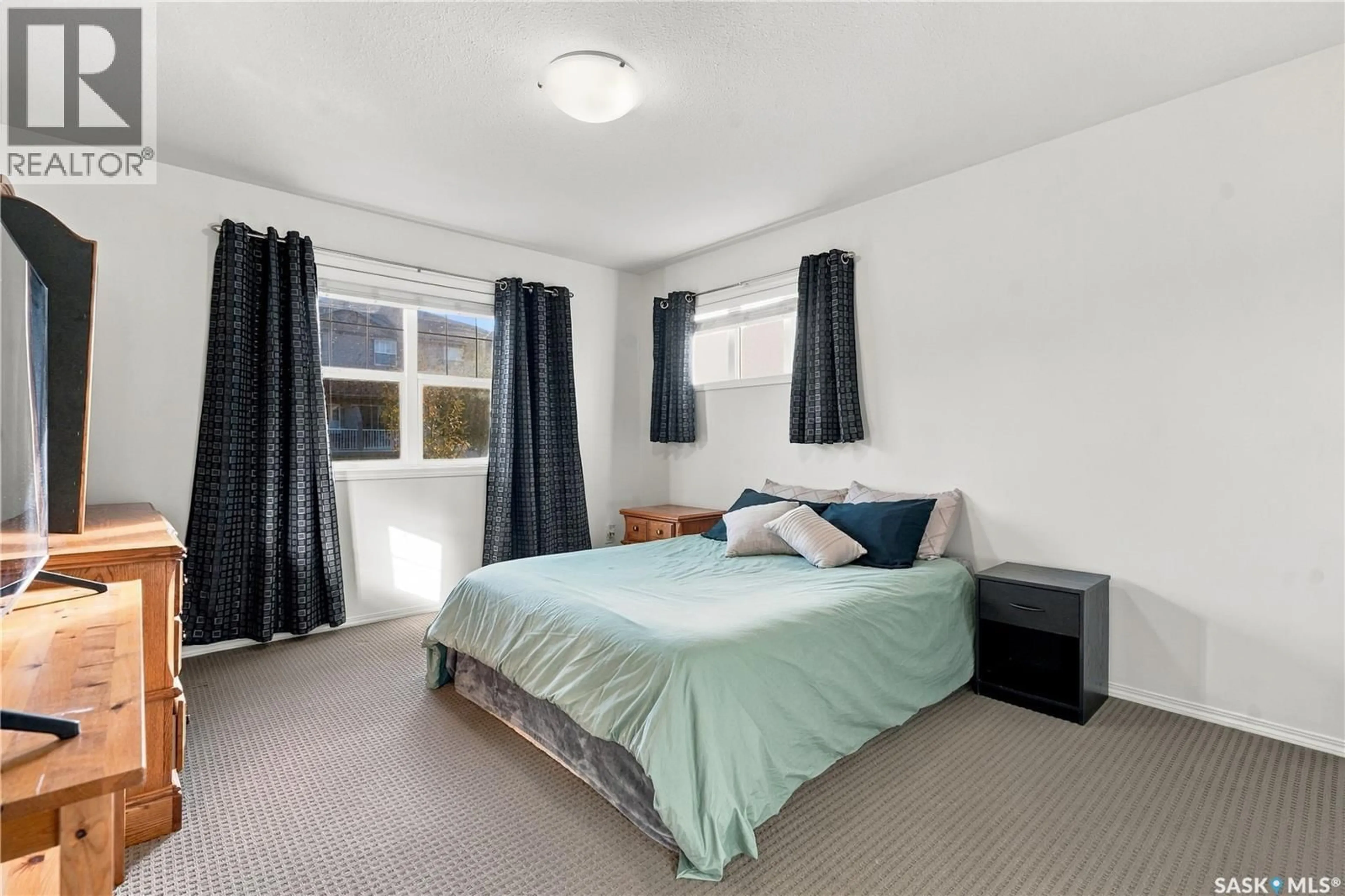 Bedroom with bed, carpet floor for 410 - 110 STENSRUD ROAD, Saskatoon Saskatchewan S7W0B7