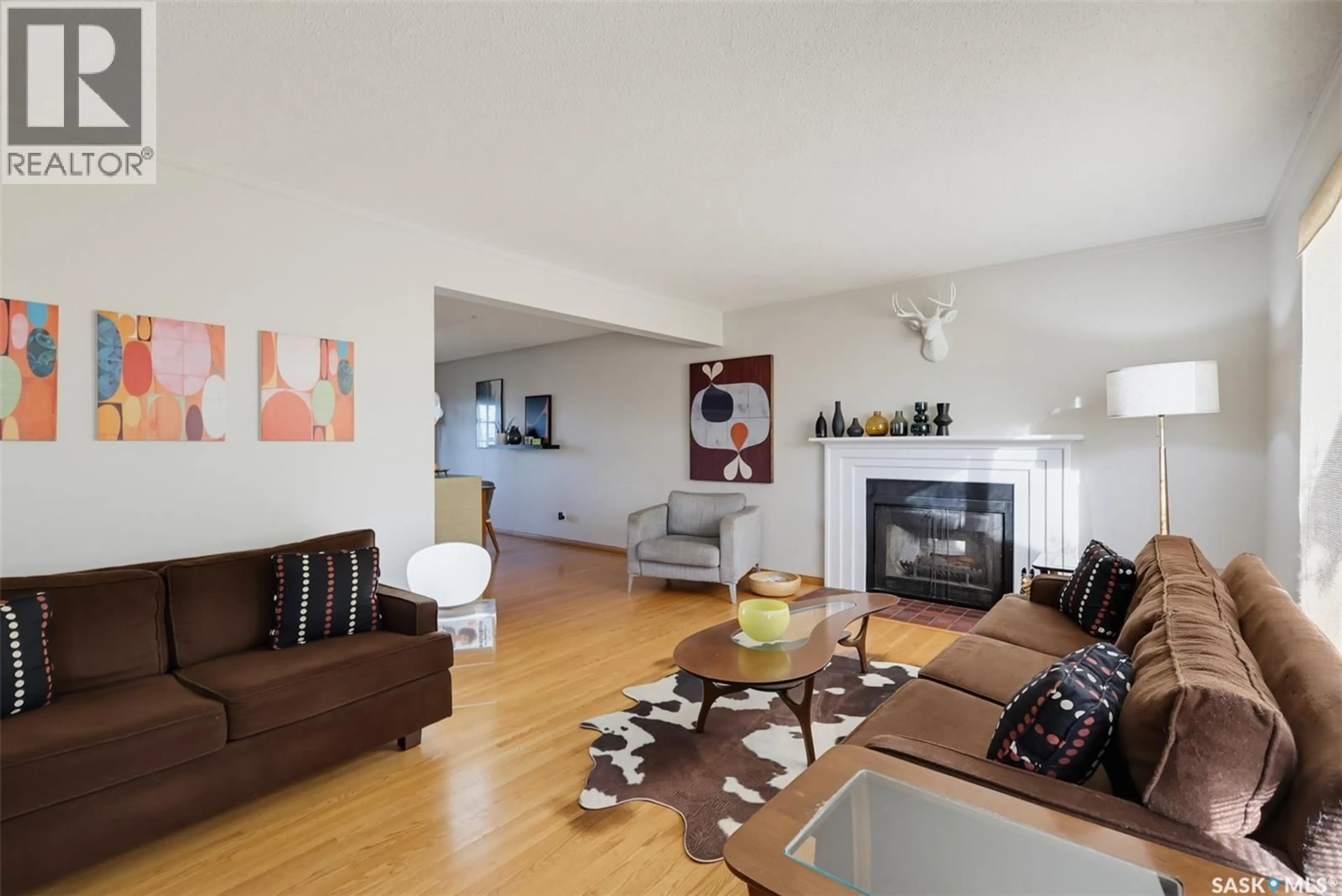 Living room with furniture, wood/laminate floor for 2457 EASTVIEW, Saskatoon Saskatchewan S7J3E8
