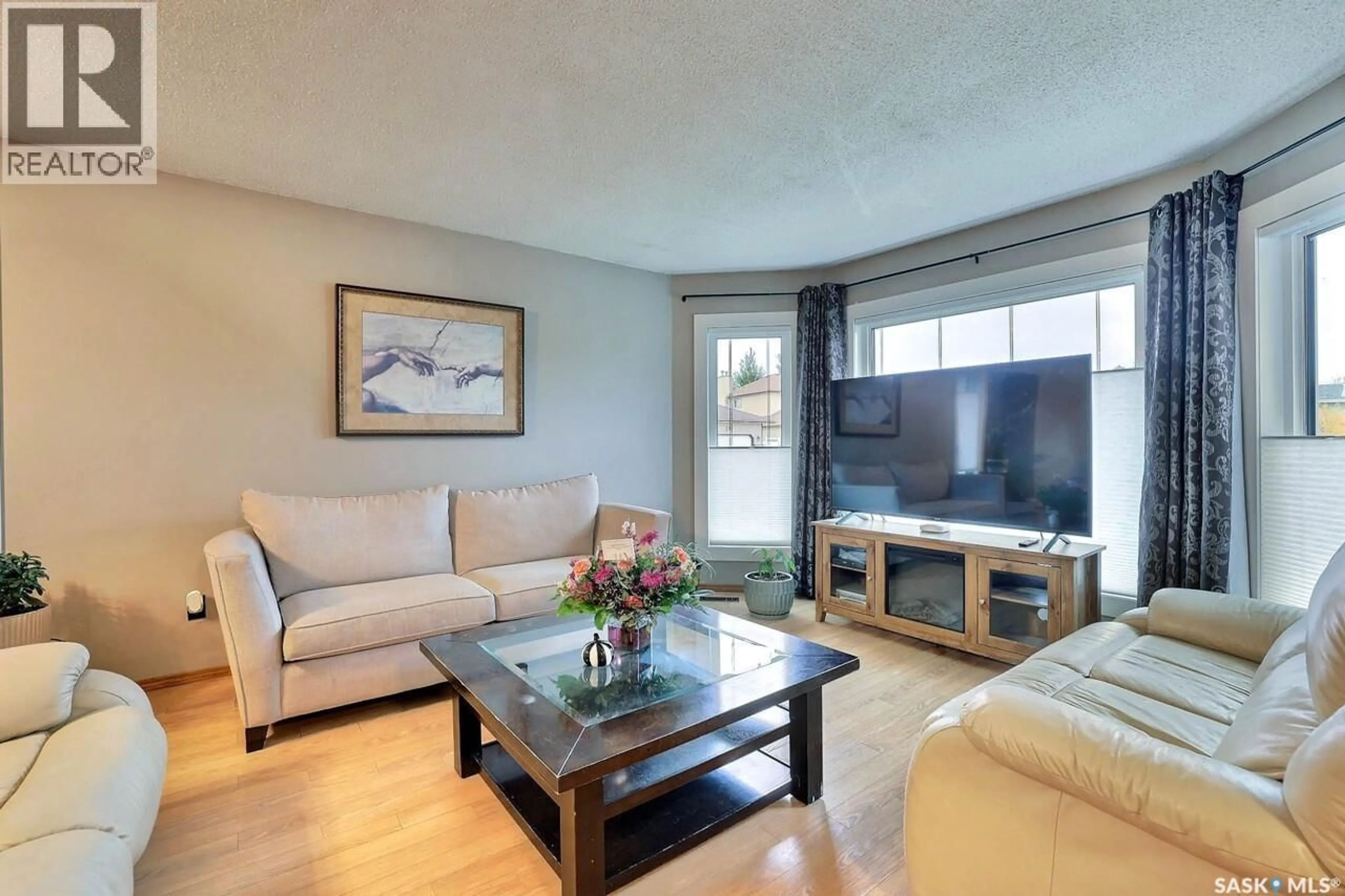 Living room with furniture, wood/laminate floor for 242 PAR PLACE, Regina Saskatchewan S4Y1H3