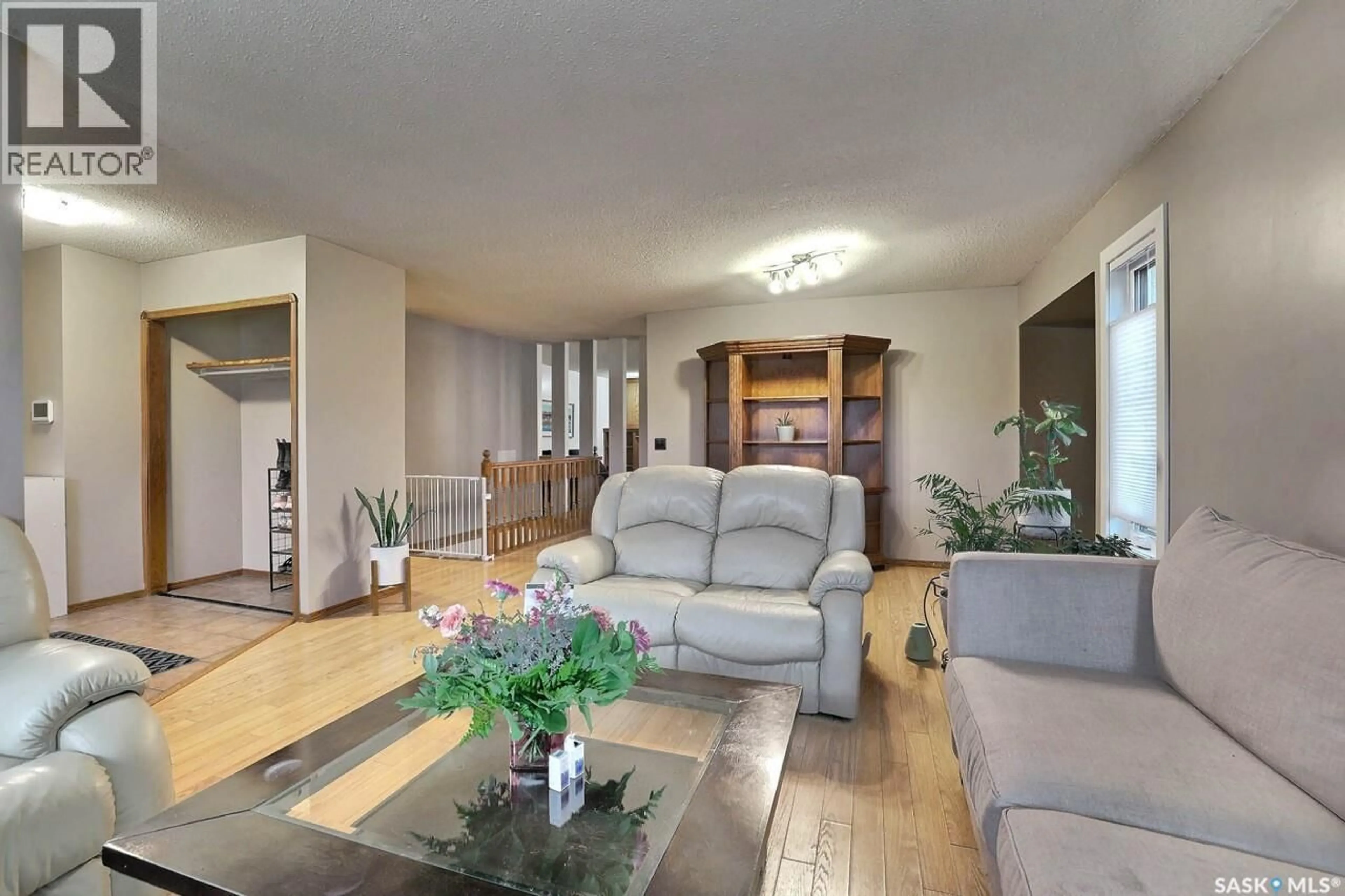 Living room with furniture, wood/laminate floor for 242 PAR PLACE, Regina Saskatchewan S4Y1H3