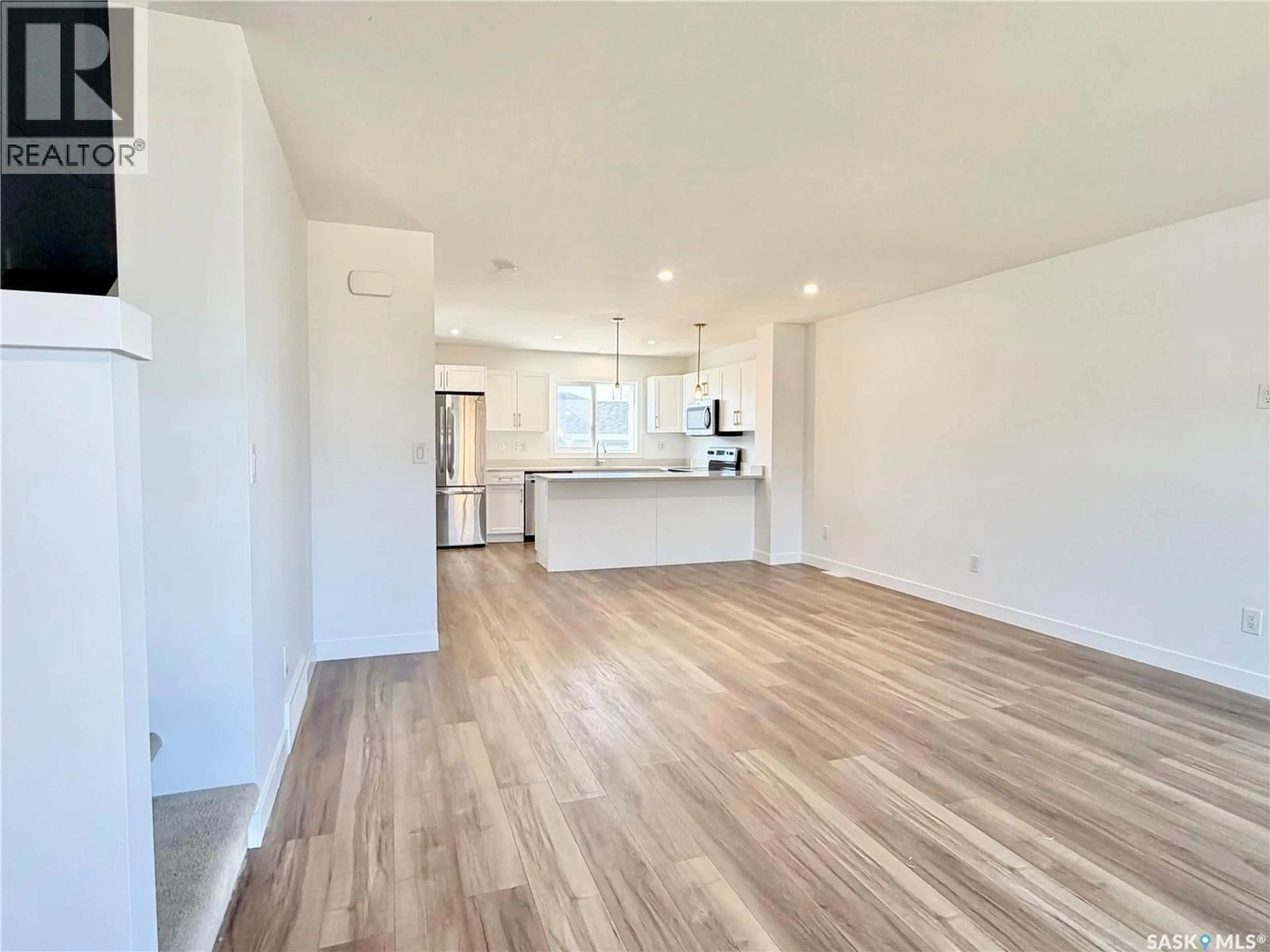 Open concept kitchen, wood/laminate floor for 106 WESTFIELD ROAD, Saskatoon Saskatchewan S7V0Z8