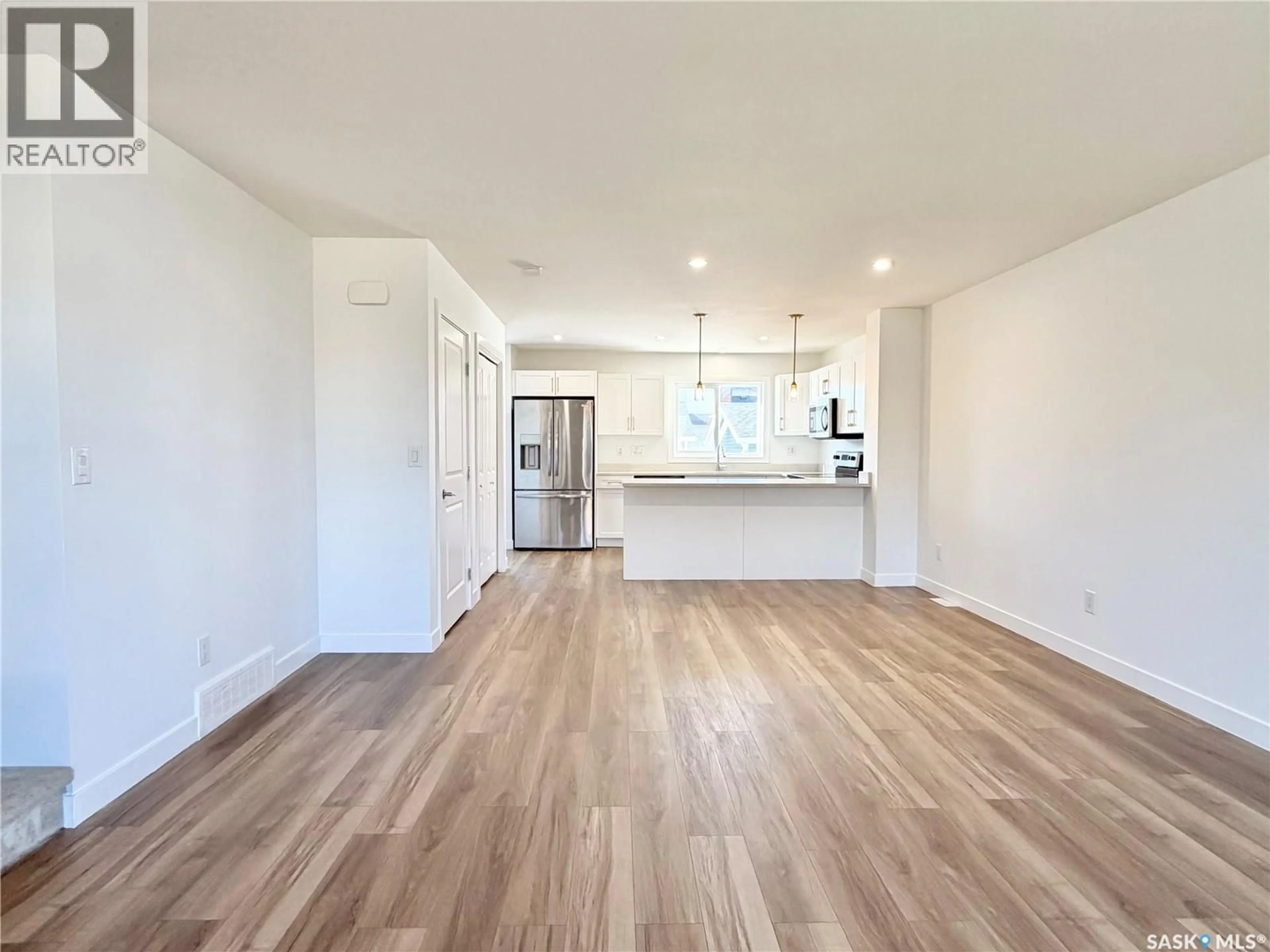 Open concept kitchen, wood/laminate floor for 106 WESTFIELD ROAD, Saskatoon Saskatchewan S7V0Z8
