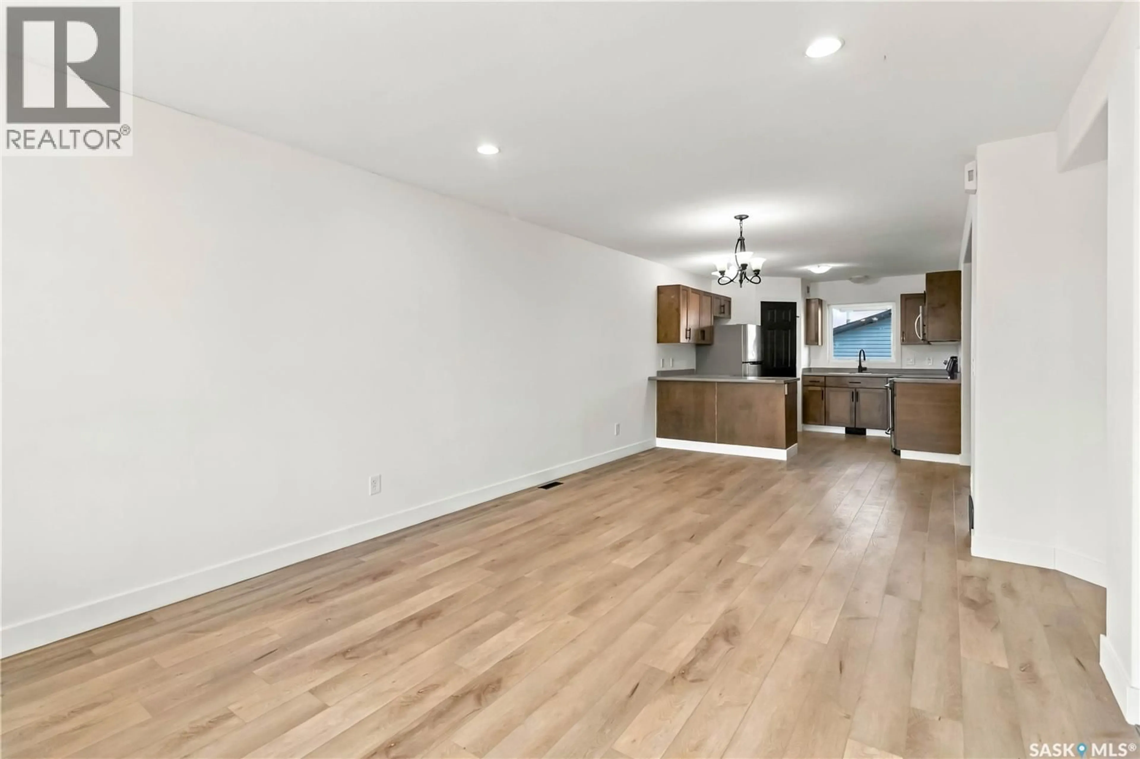 Open concept kitchen, wood/laminate floor for 734 LAMARSH LANE, Saskatoon Saskatchewan S0K4S3