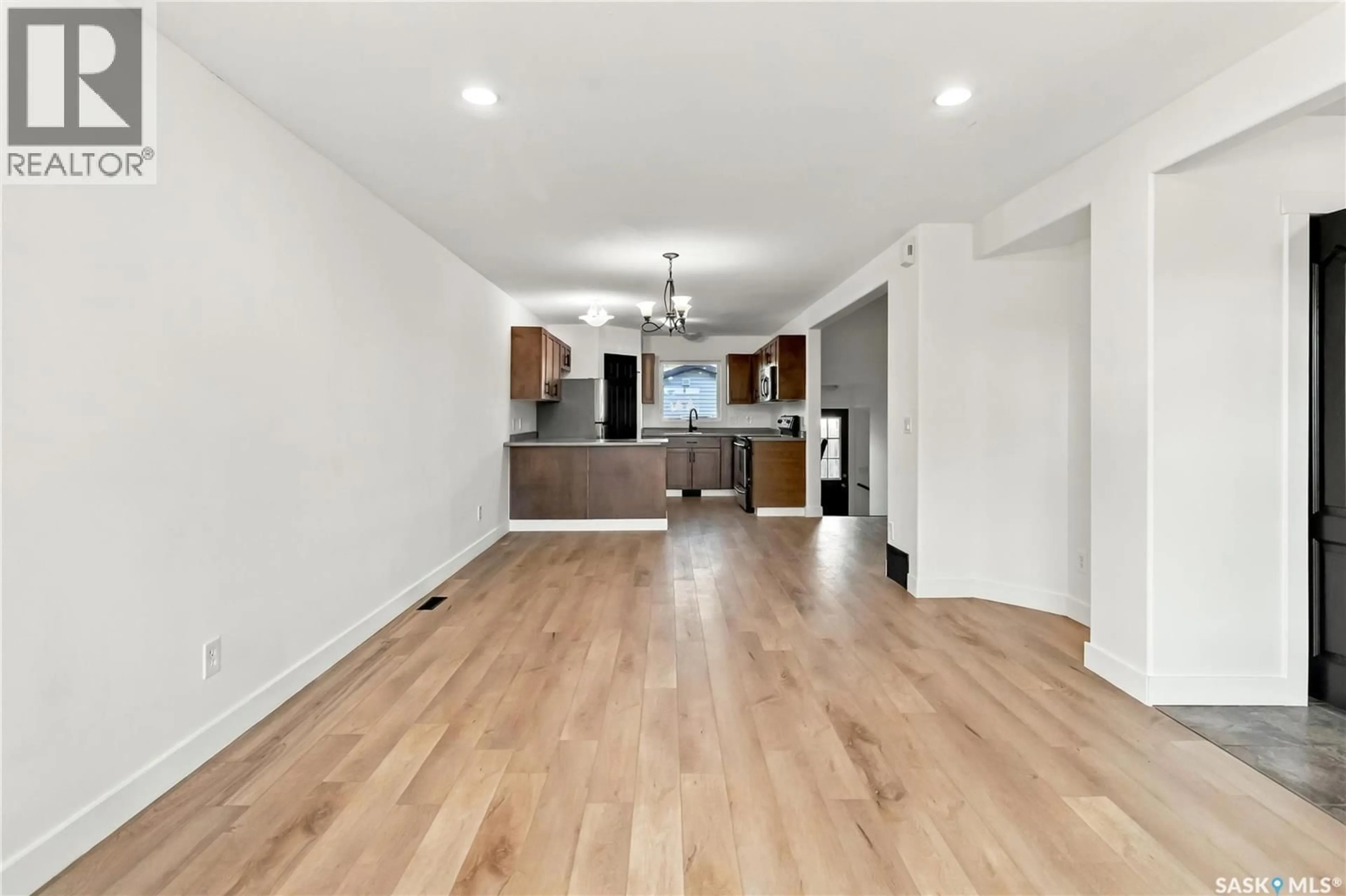 Open concept kitchen, wood/laminate floor for 734 LAMARSH LANE, Saskatoon Saskatchewan S0K4S3