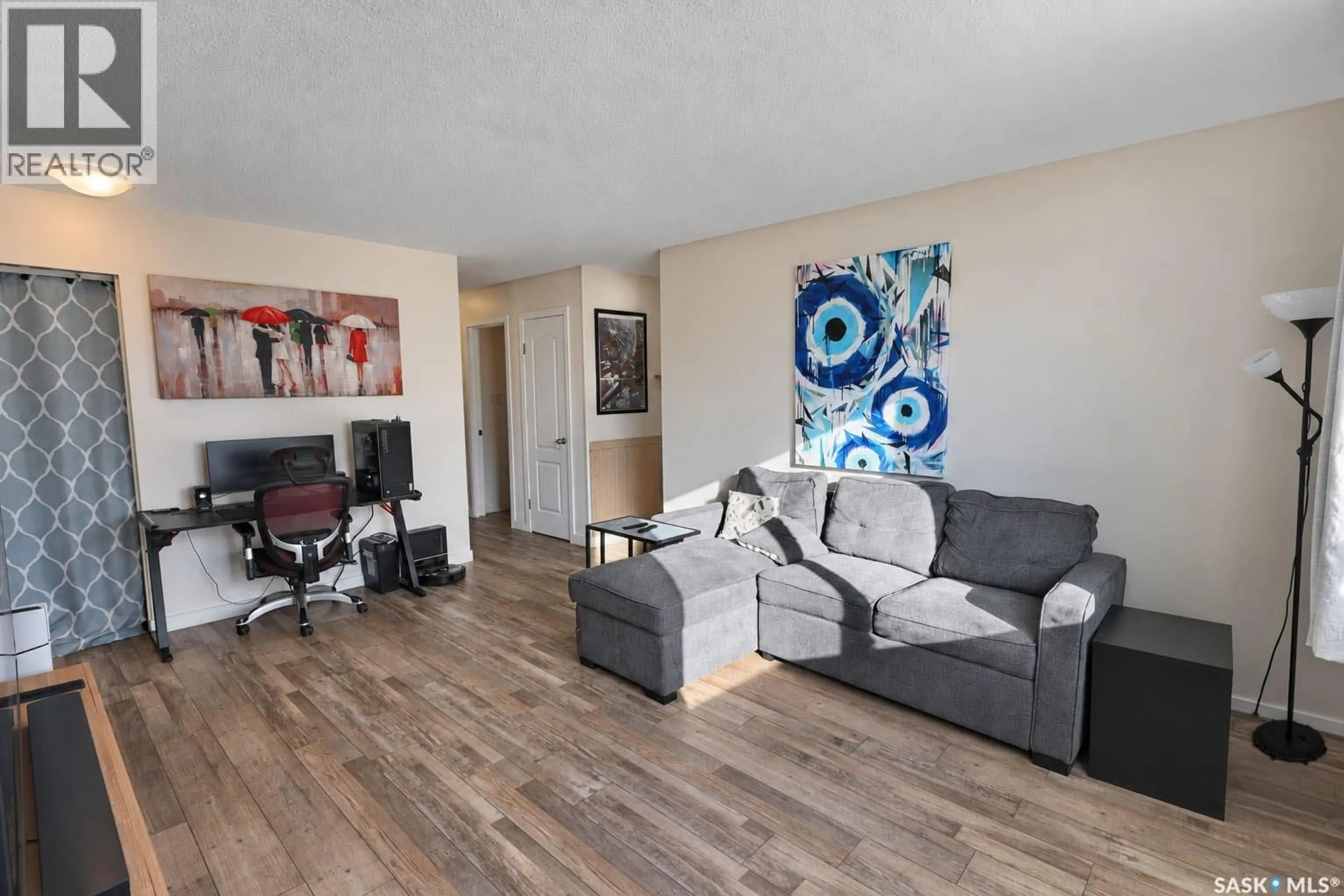 Living room with furniture, wood/laminate floor for 88 BOWERMAN CRESCENT, Prince Albert Saskatchewan S6V6G4