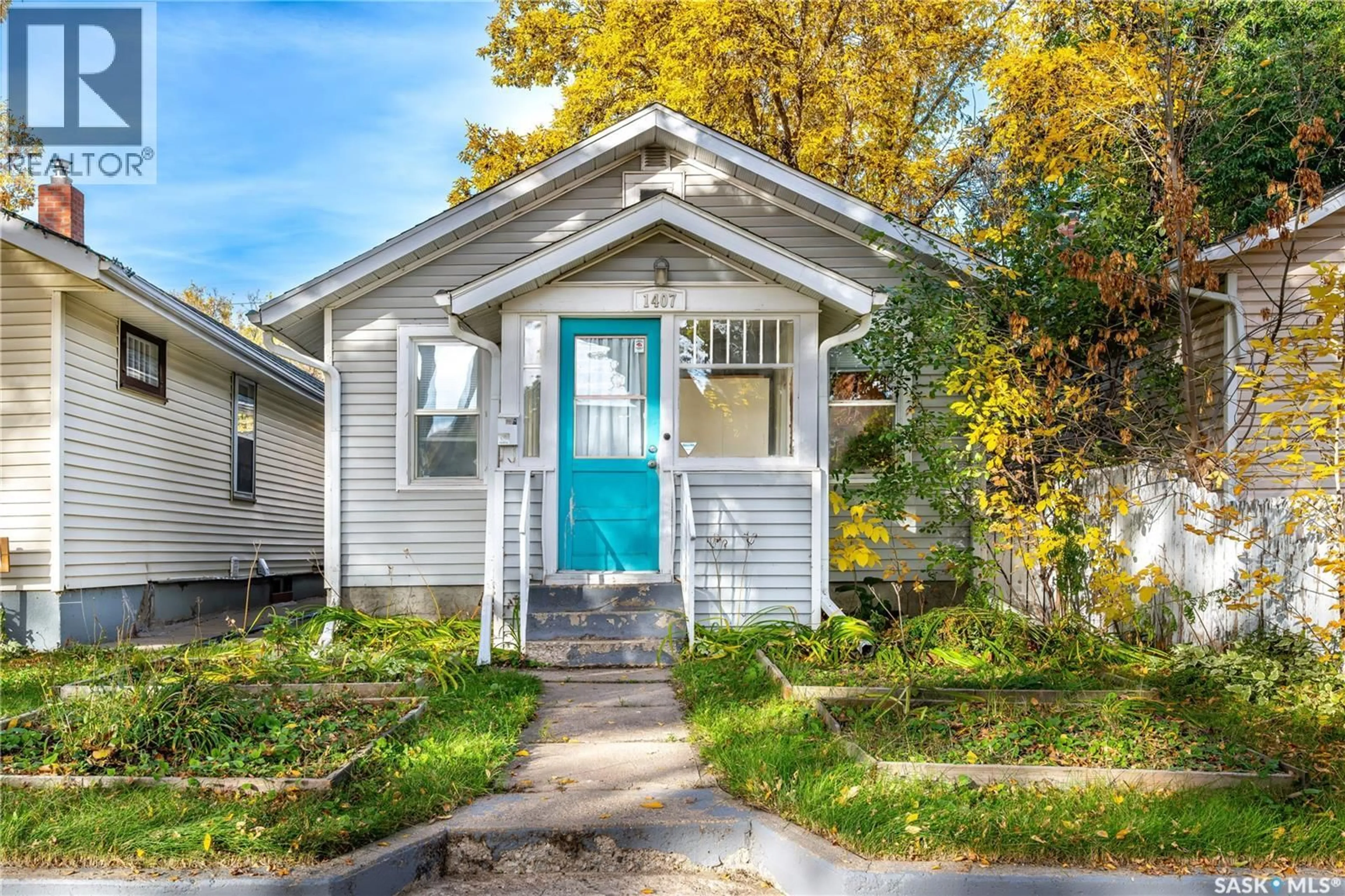 Home with vinyl exterior material, street for 1407 C AVENUE, Saskatoon Saskatchewan S7L1K9