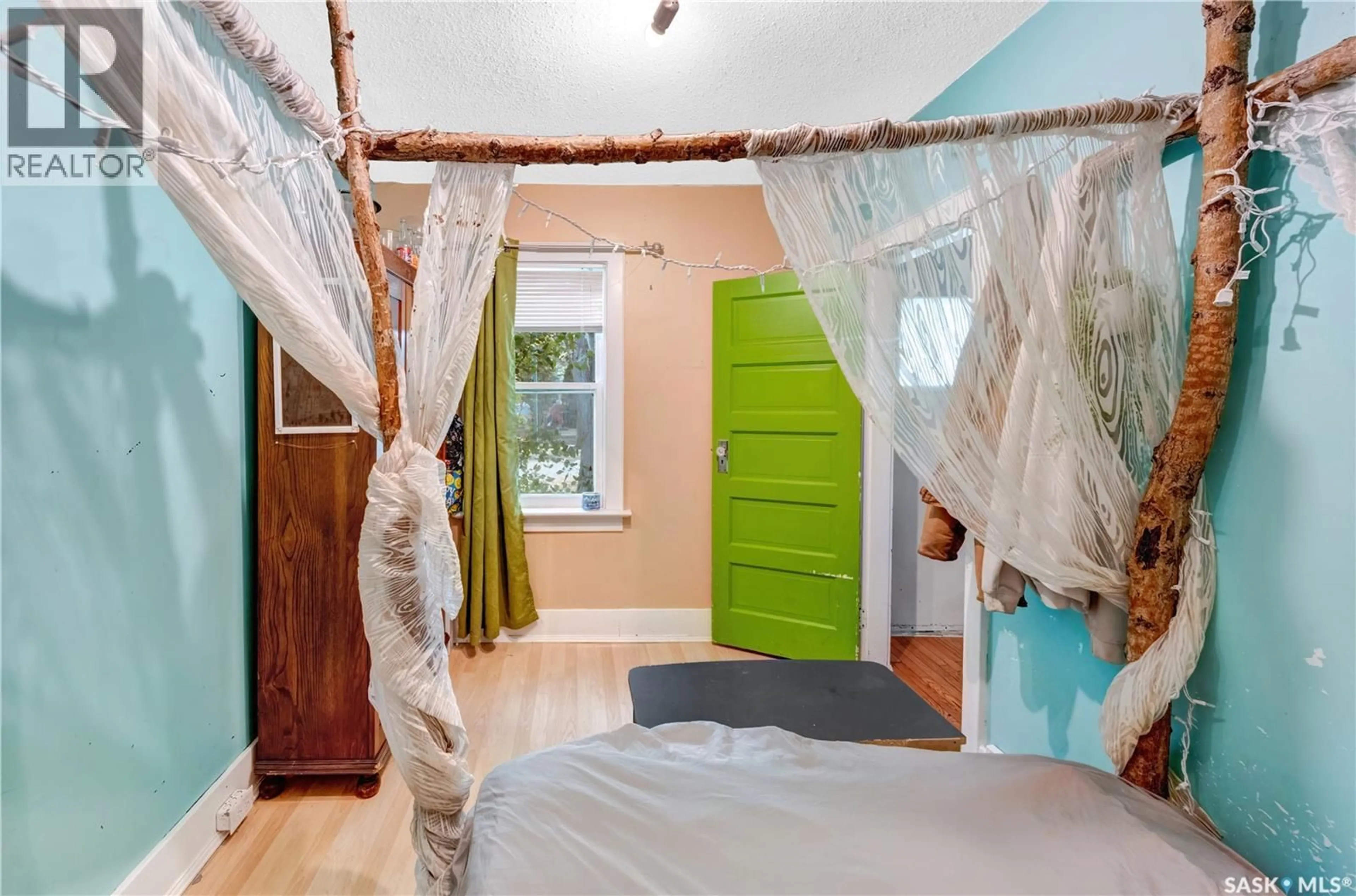 Bedroom with bed, wood/laminate floor for 1407 C AVENUE, Saskatoon Saskatchewan S7L1K9