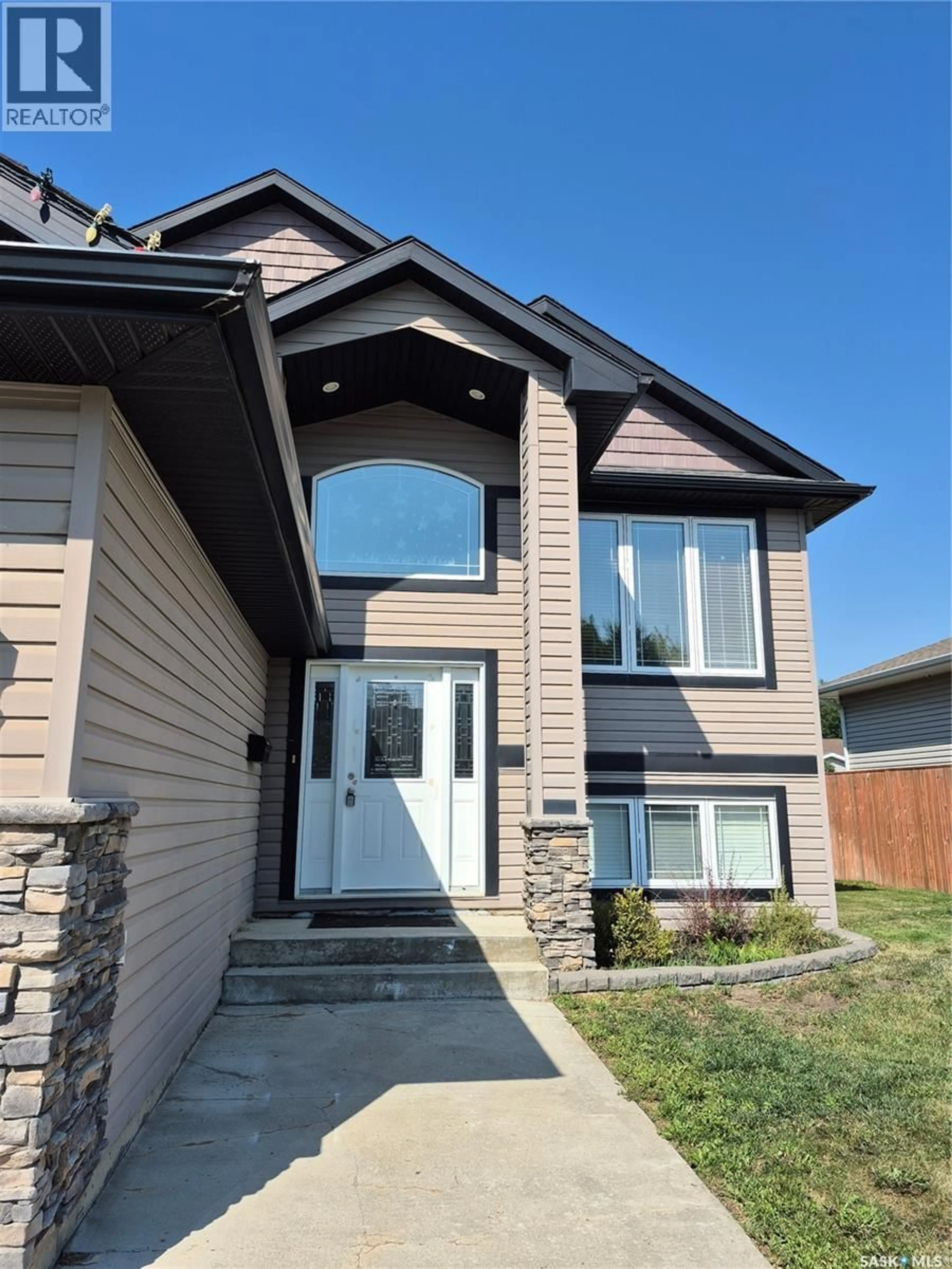 Home with vinyl exterior material, street for 10321 HENDERSON DRIVE, North Battleford Saskatchewan S9Z3Y9