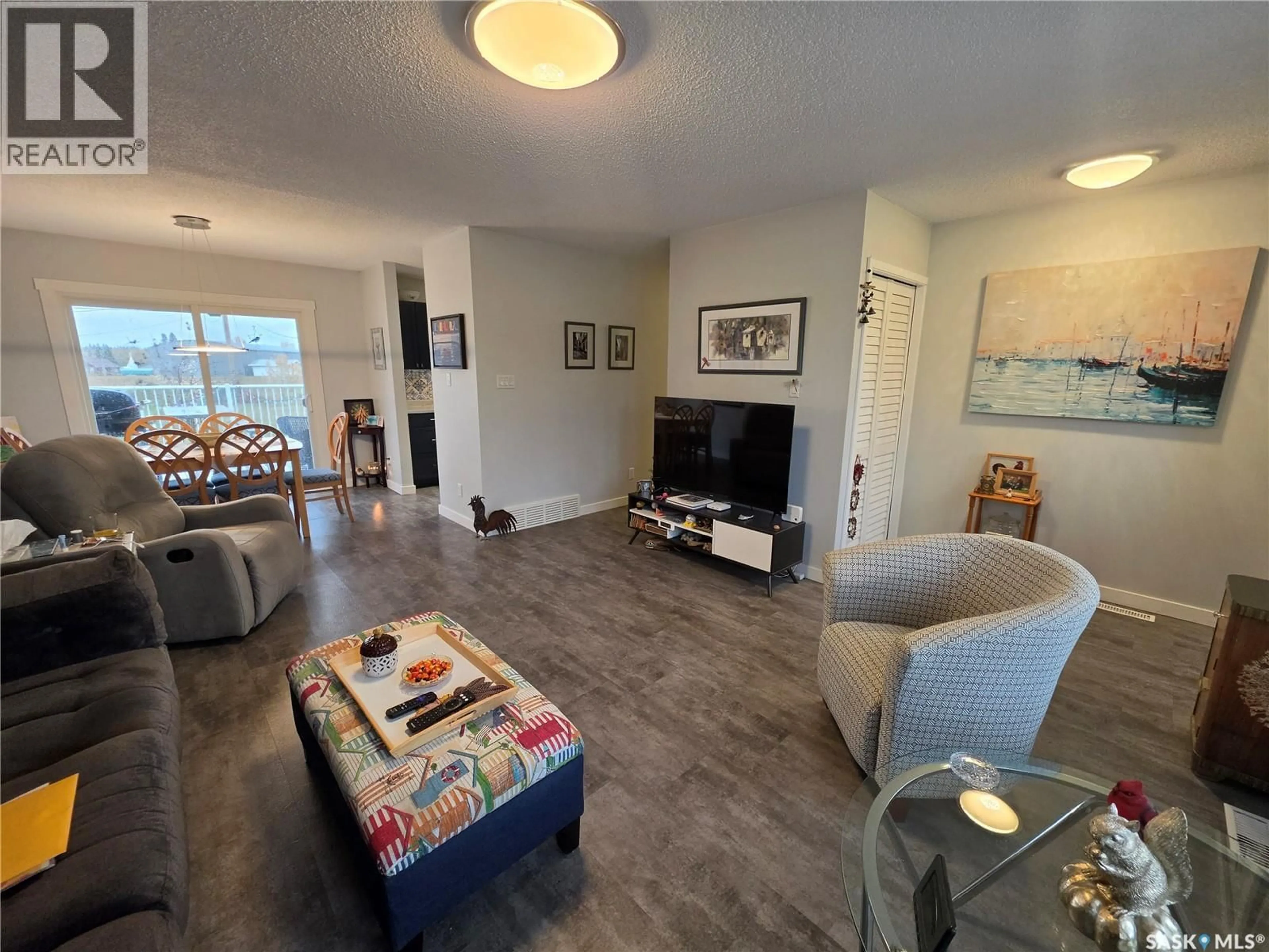 Living room with furniture, wood/laminate floor for 306 2ND STREET, Goodsoil Saskatchewan S0M1A0