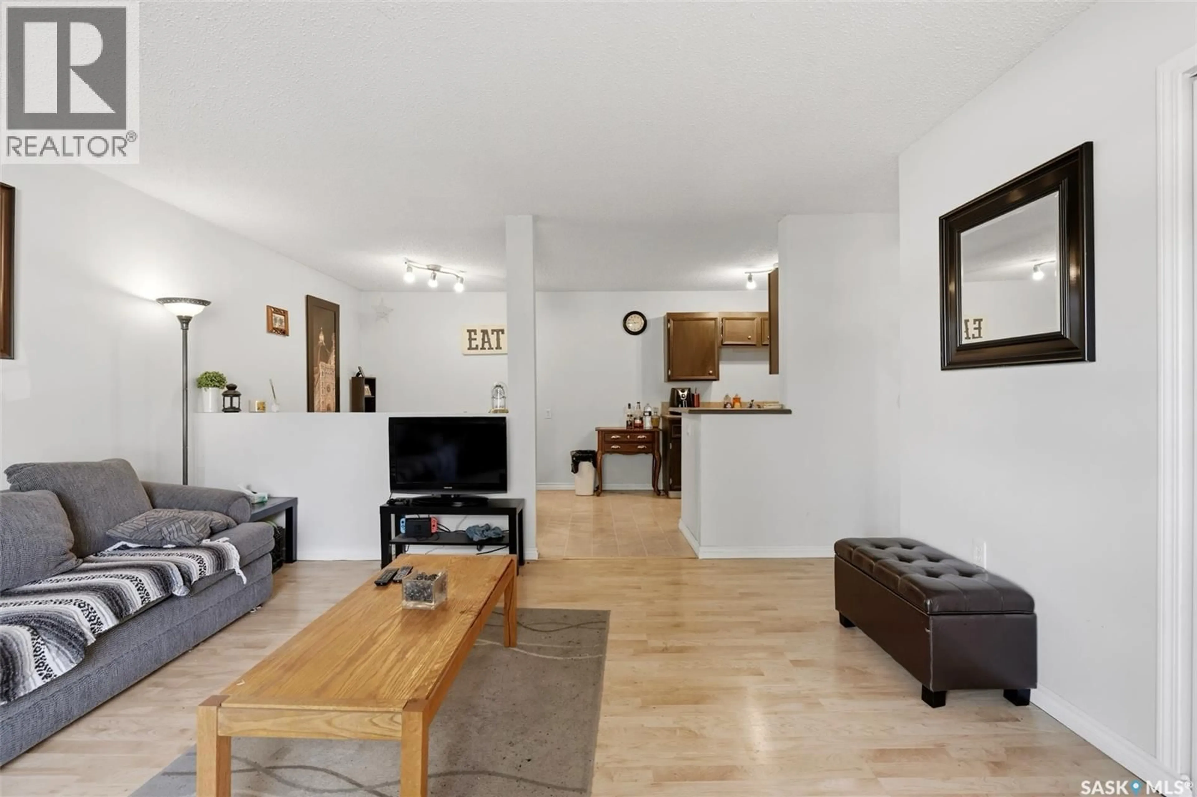 Living room with furniture, wood/laminate floor for 202 - 2511 NEFF ROAD, Regina Saskatchewan S4V1C1