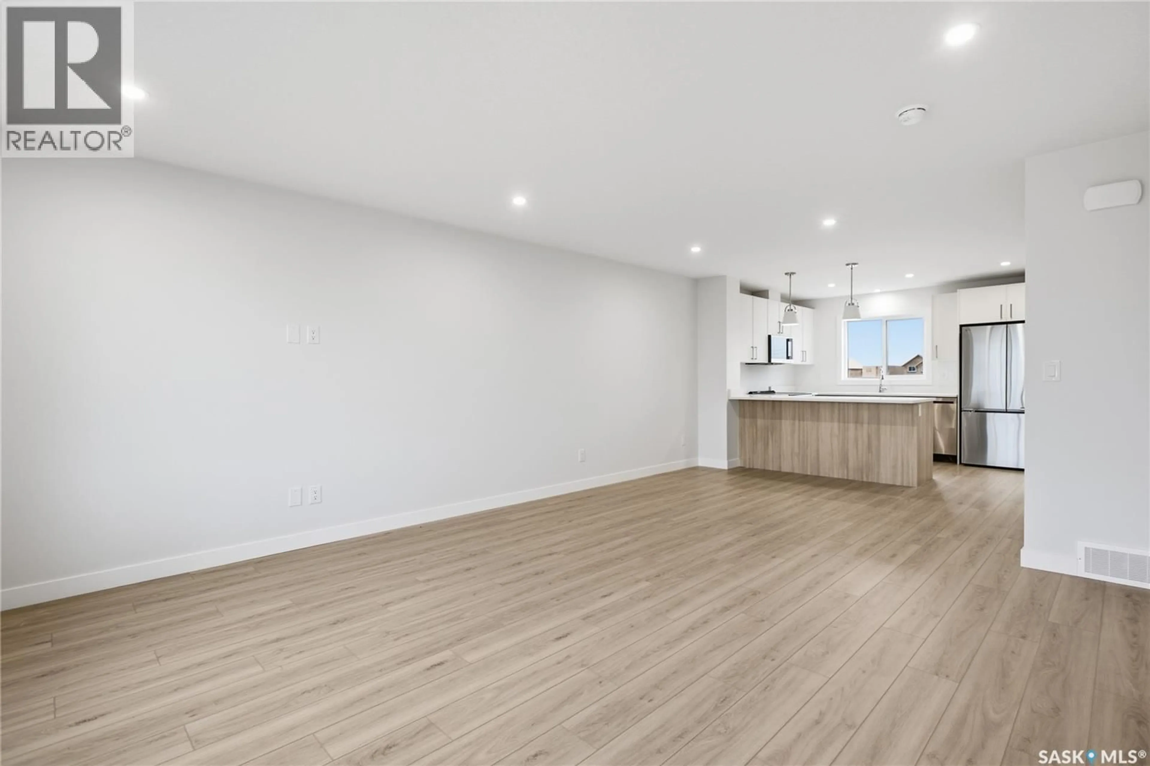 Open concept kitchen, wood/laminate floor for 273 MARK BEND, Saskatoon Saskatchewan S7V2B8