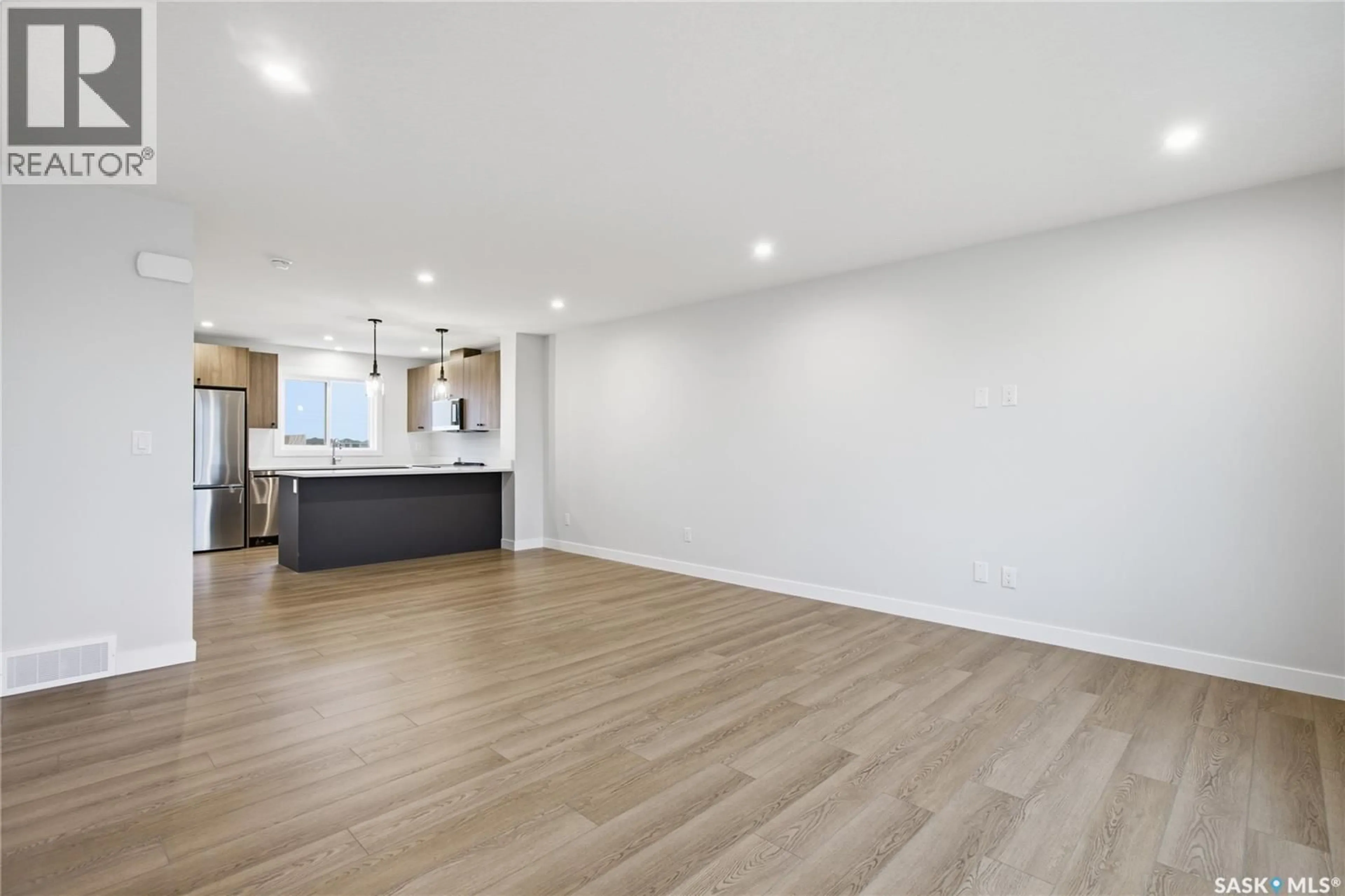 Open concept kitchen, wood/laminate floor for 279 MARK BEND, Saskatoon Saskatchewan S7V2B8