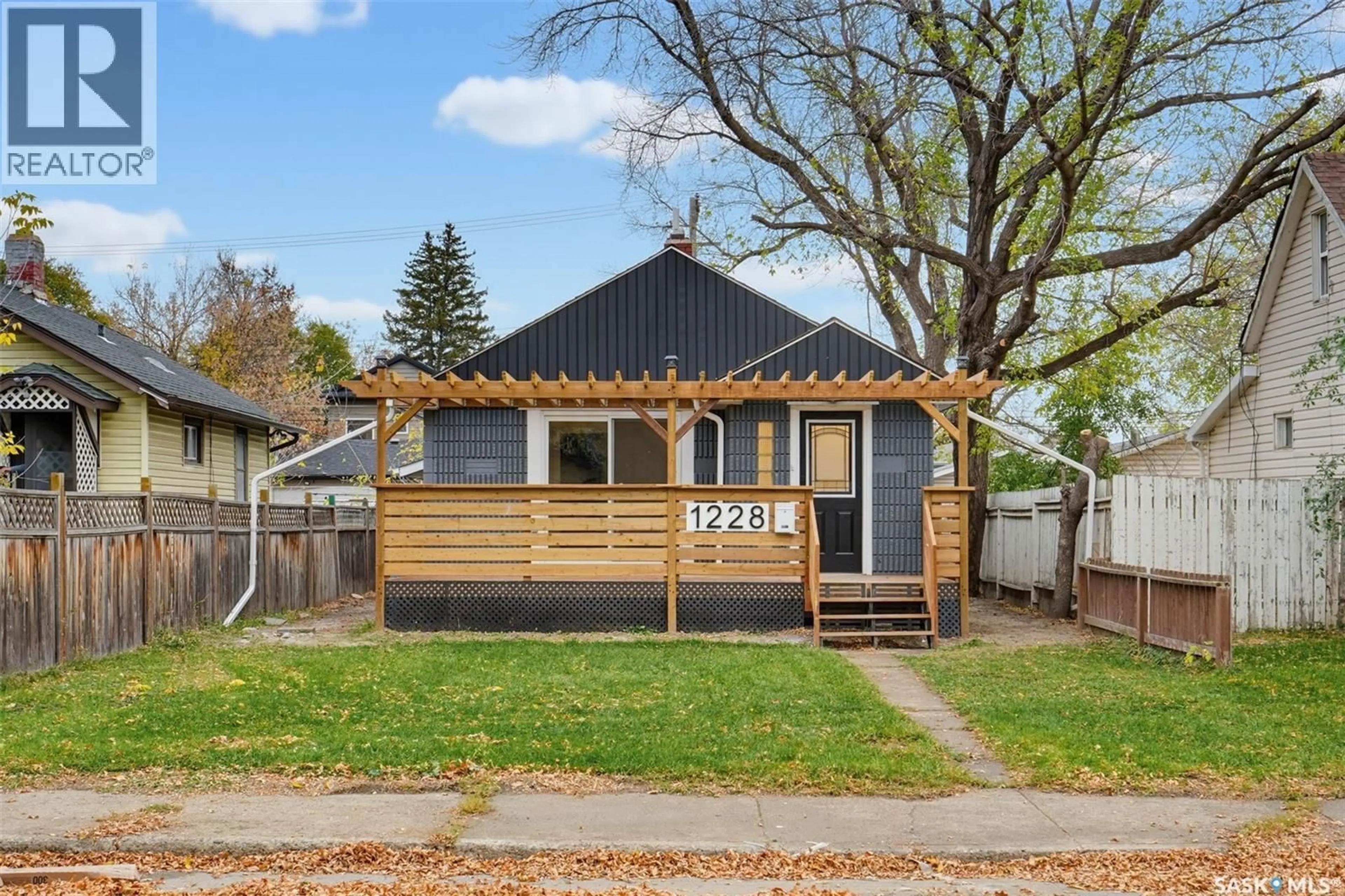 Home with vinyl exterior material, street for 1228 1ST AVENUE, Saskatoon Saskatchewan S7K1Y6