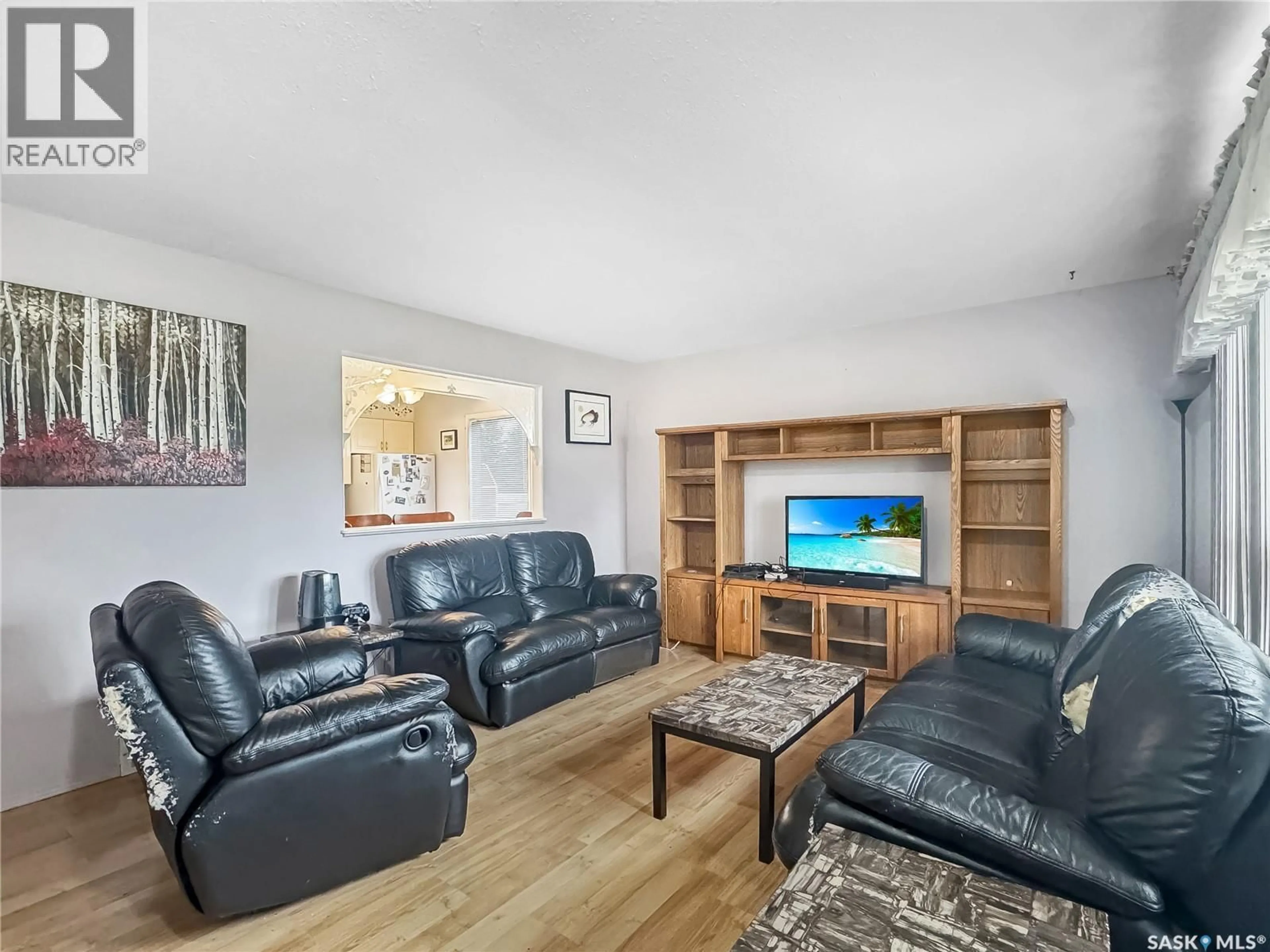 Living room with furniture, wood/laminate floor for 117 HUDEK AVENUE, Hafford Saskatchewan S0J1A0
