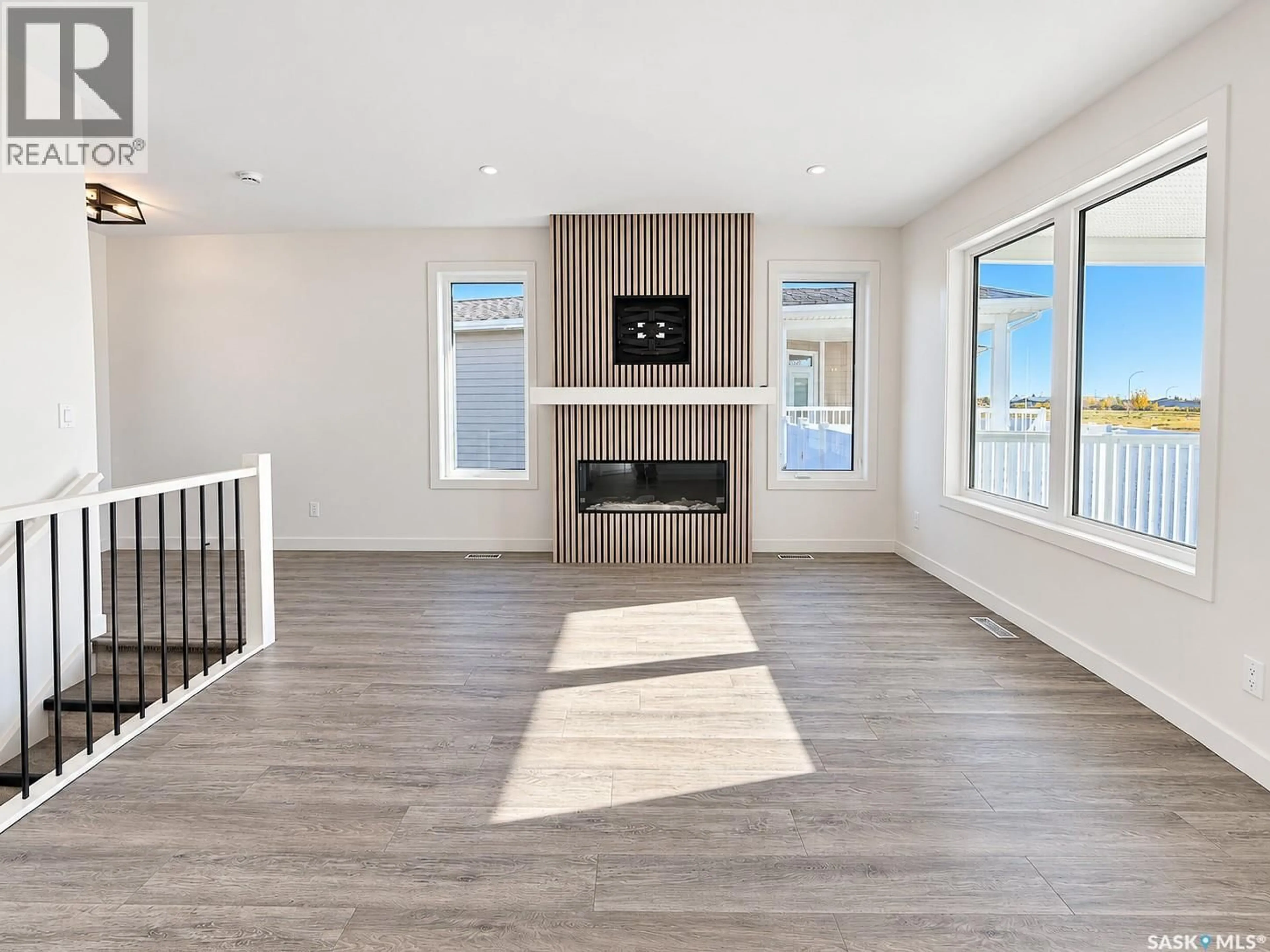 Living room with furniture, wood/laminate floor for 2604 SANDPIPER ROAD, North Battleford Saskatchewan S9A3Z3
