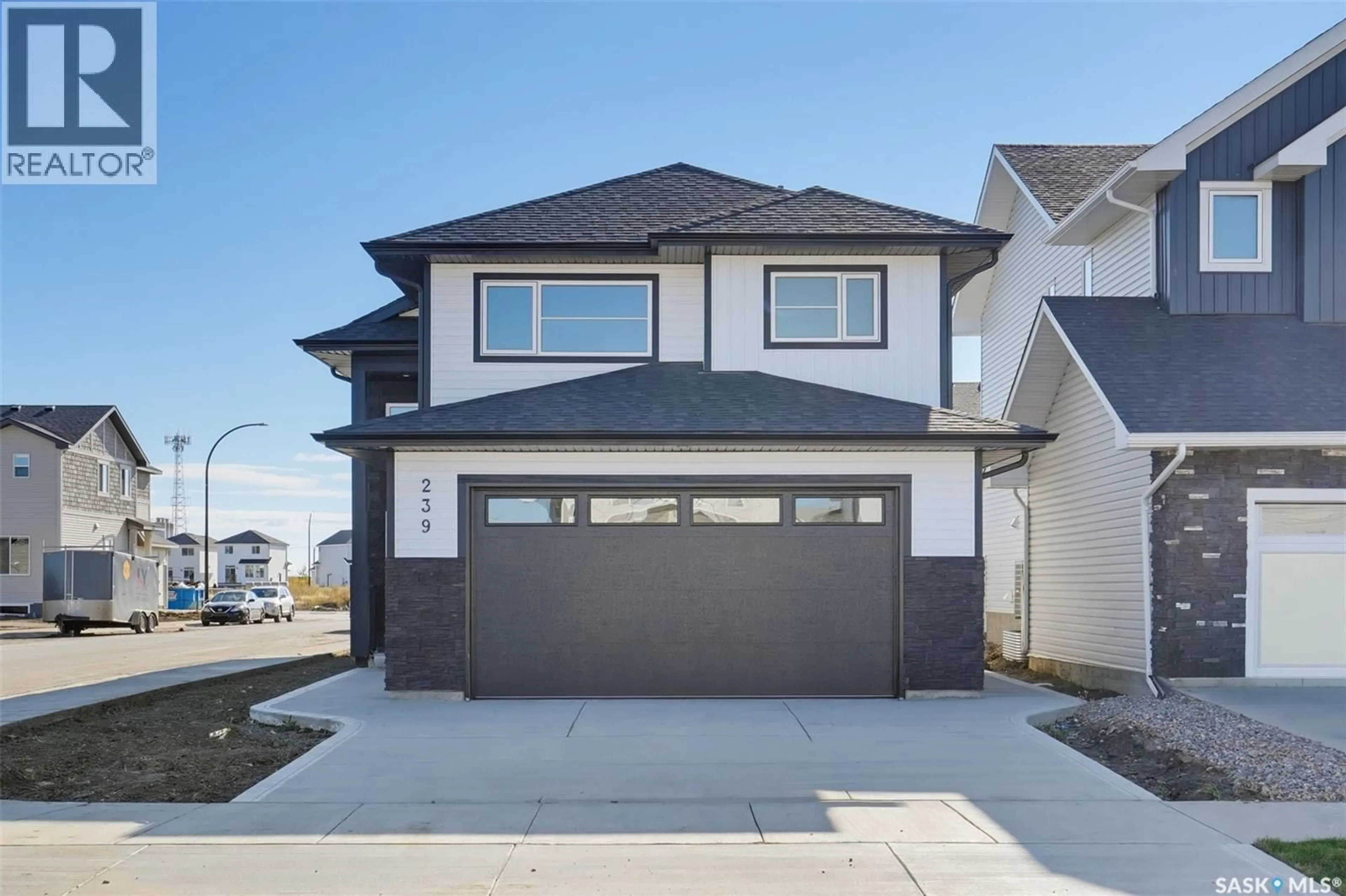 Home with vinyl exterior material, street for 239 TASKAMANWA STREET, Saskatoon Saskatchewan S7V1X3