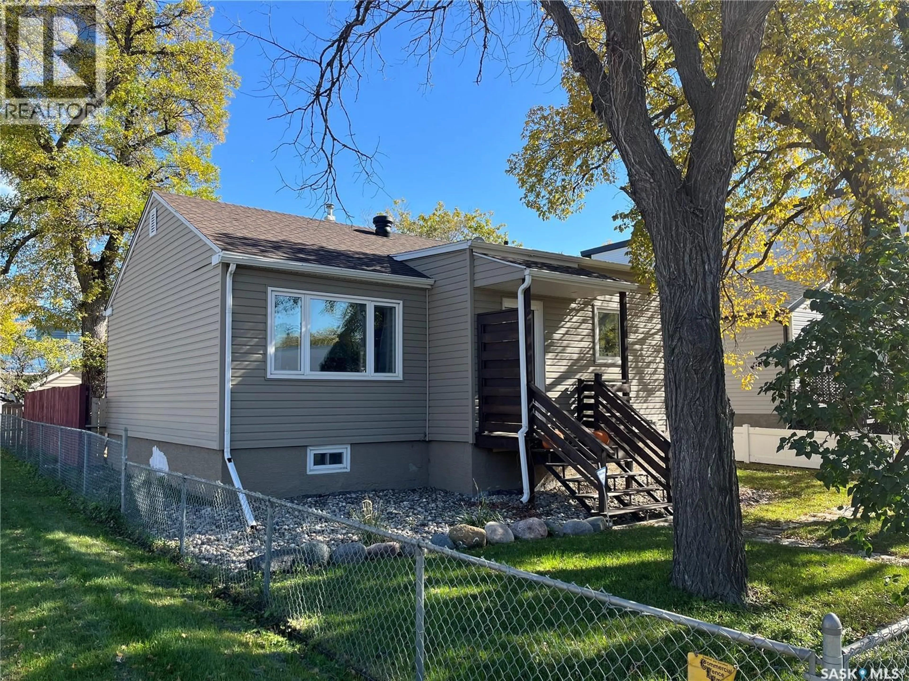 Home with vinyl exterior material, street for 2101 KING STREET, Regina Saskatchewan S4T4G9