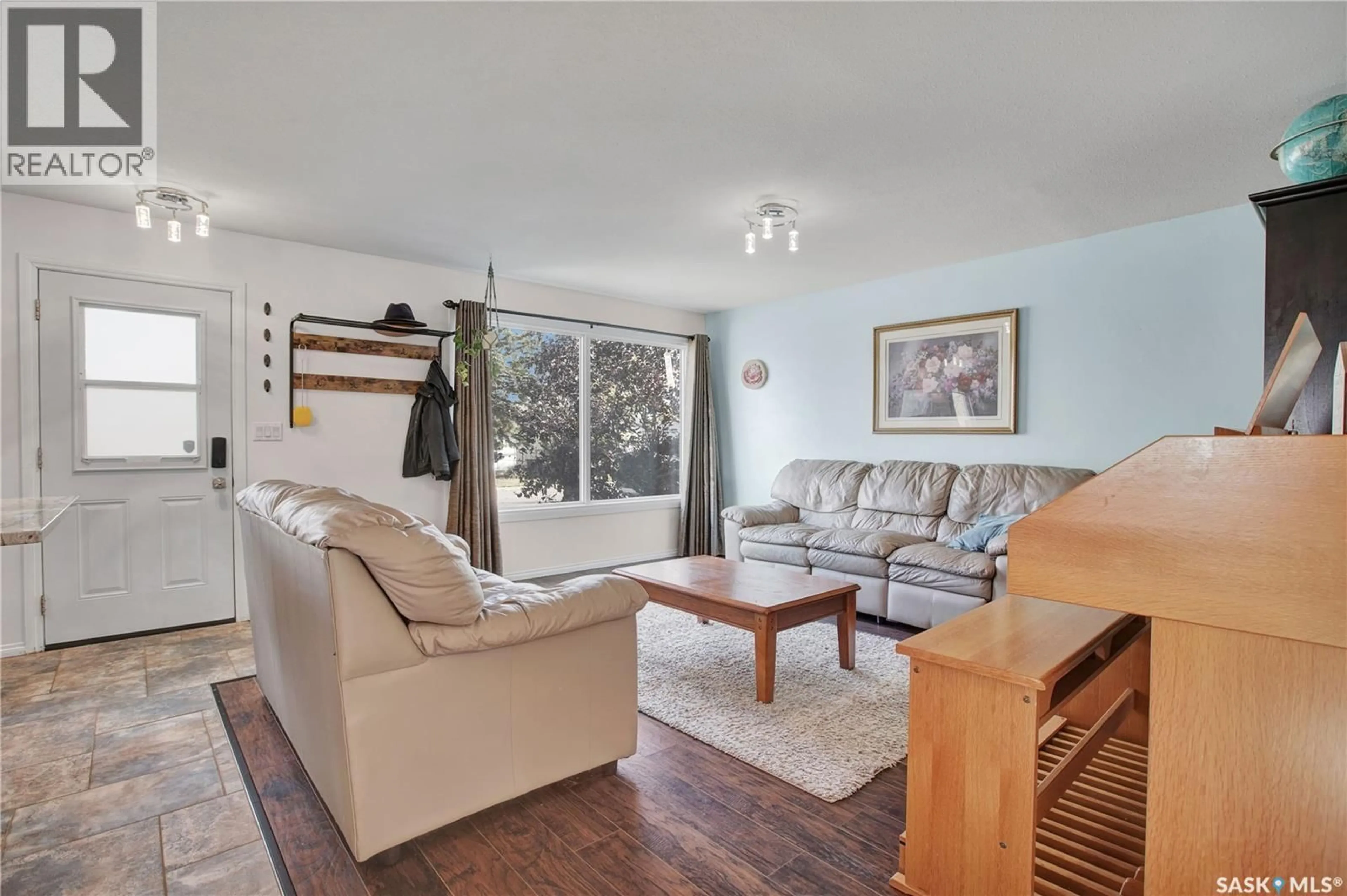Living room with furniture, wood/laminate floor for 2017 9TH STREET, Rosthern Saskatchewan S0K4R0