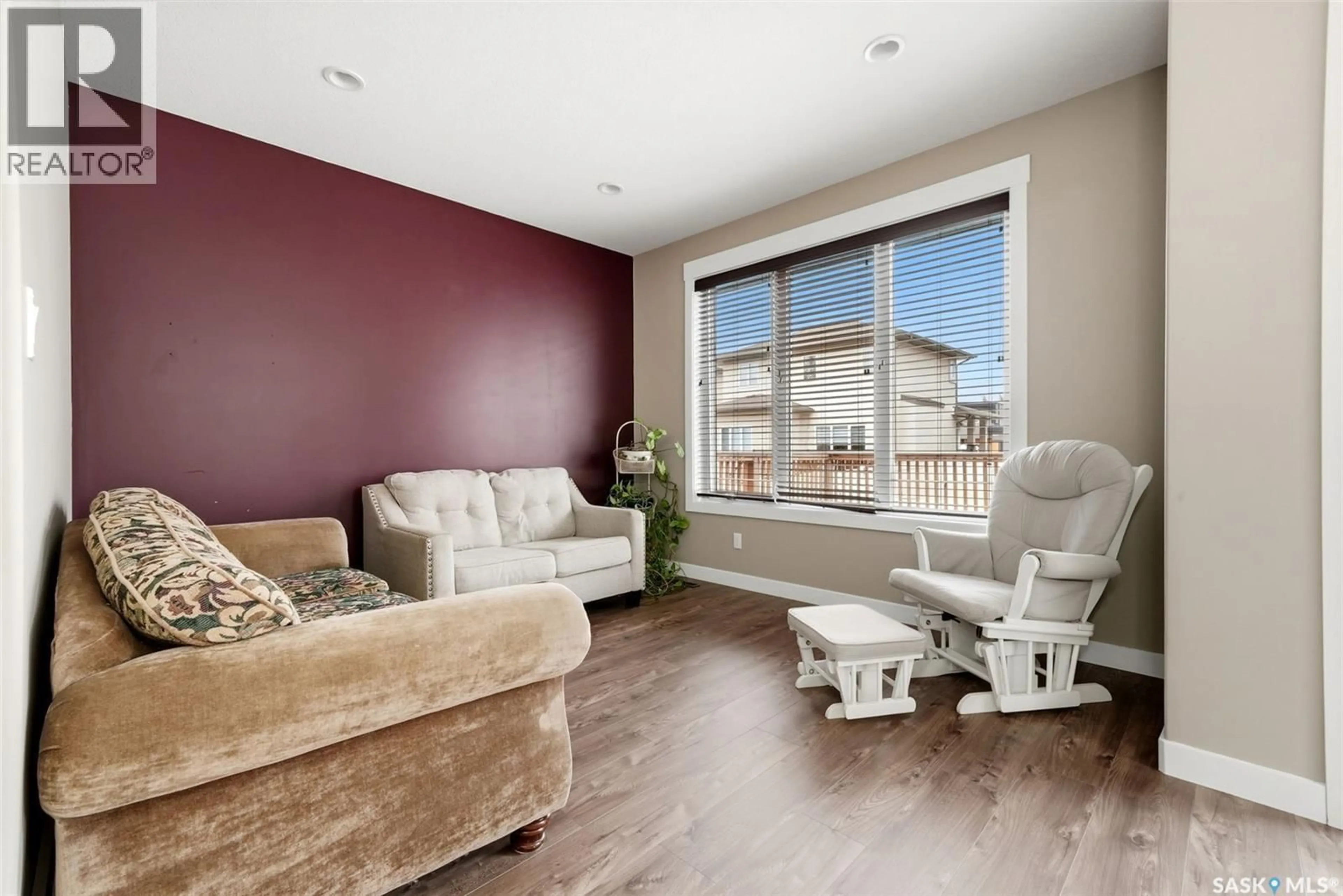 Living room with furniture, wood/laminate floor for 5213 CANUCK CRESCENT, Regina Saskatchewan S4W0H1