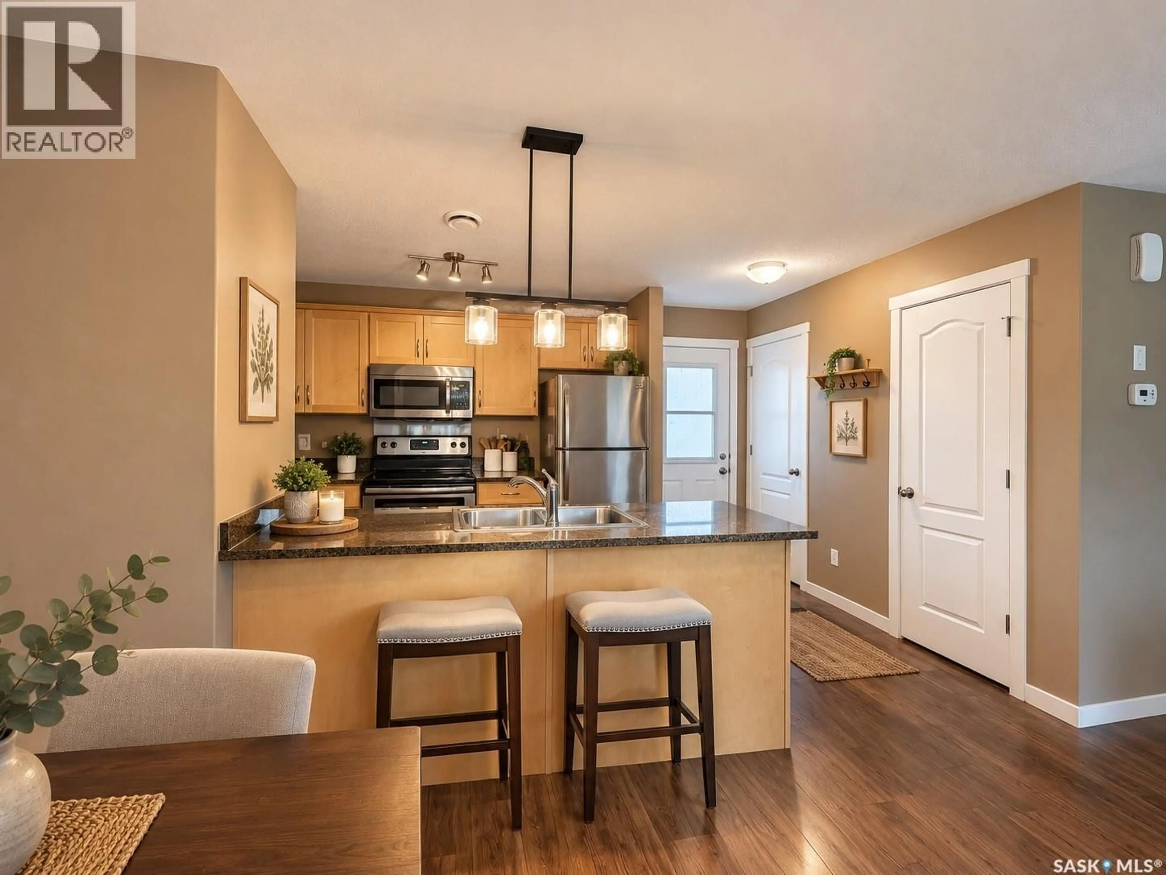 Open concept kitchen, wood/laminate floor for 1253 GREY STREET, Regina Saskatchewan S4T1G7