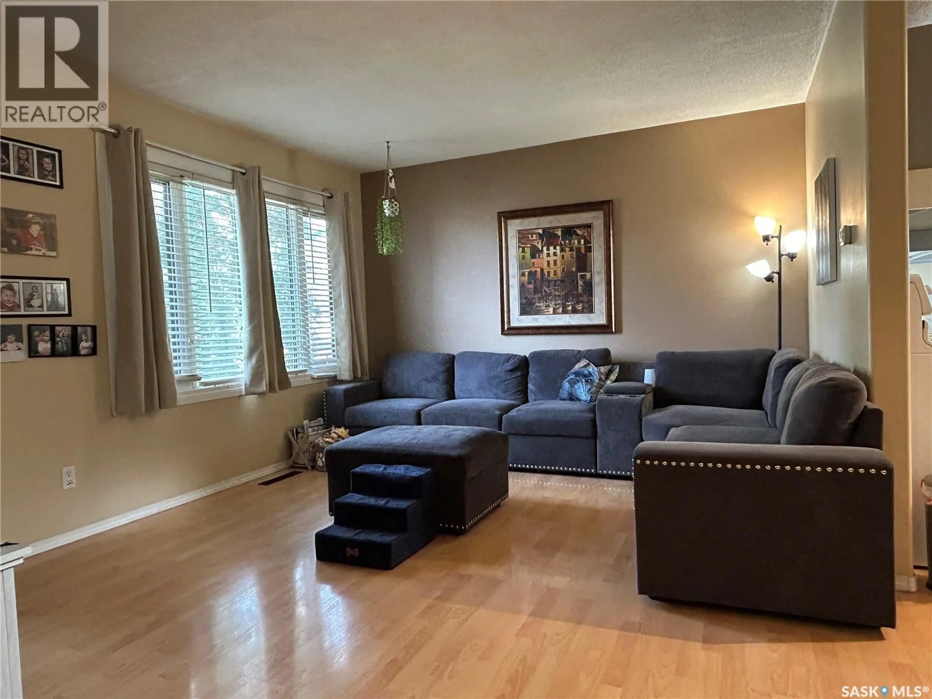 Living room with furniture, wood/laminate floor for 714 CARBON AVENUE, Bienfait Saskatchewan S0C0M0
