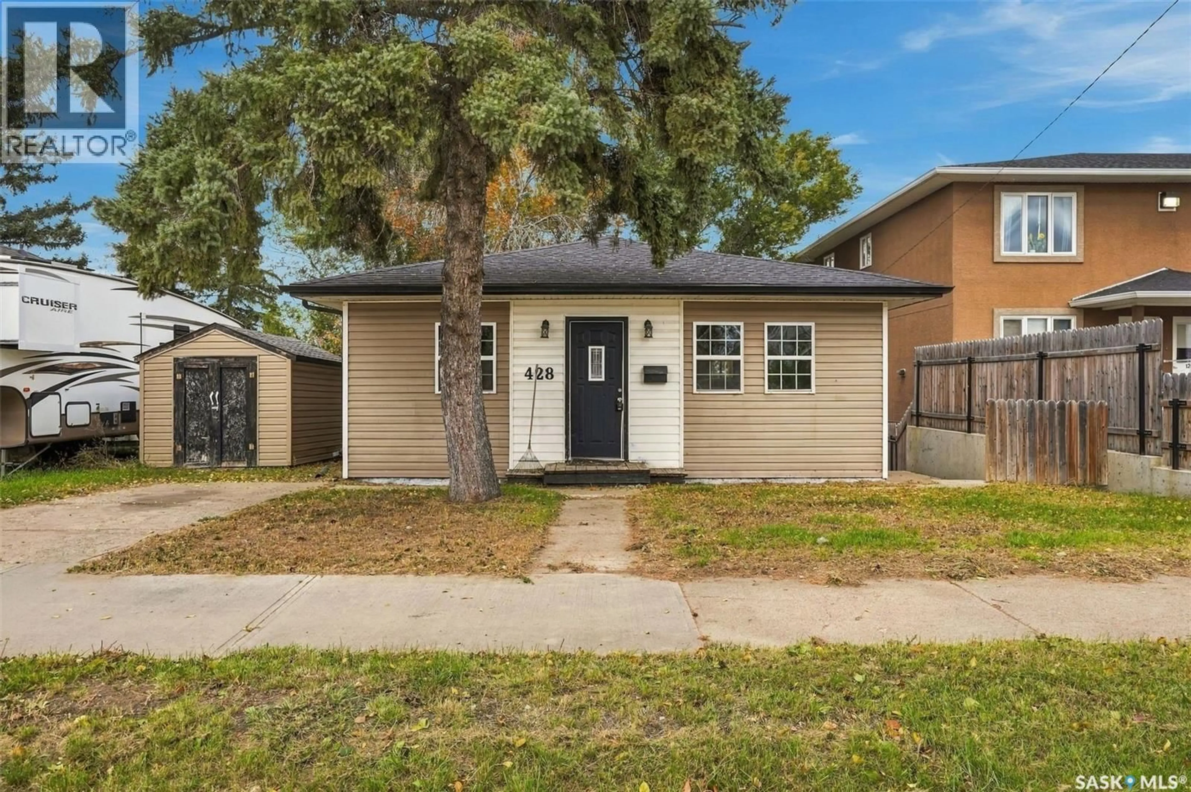 Home with vinyl exterior material, street for 428 HOME STREET, Moose Jaw Saskatchewan S6H4X8