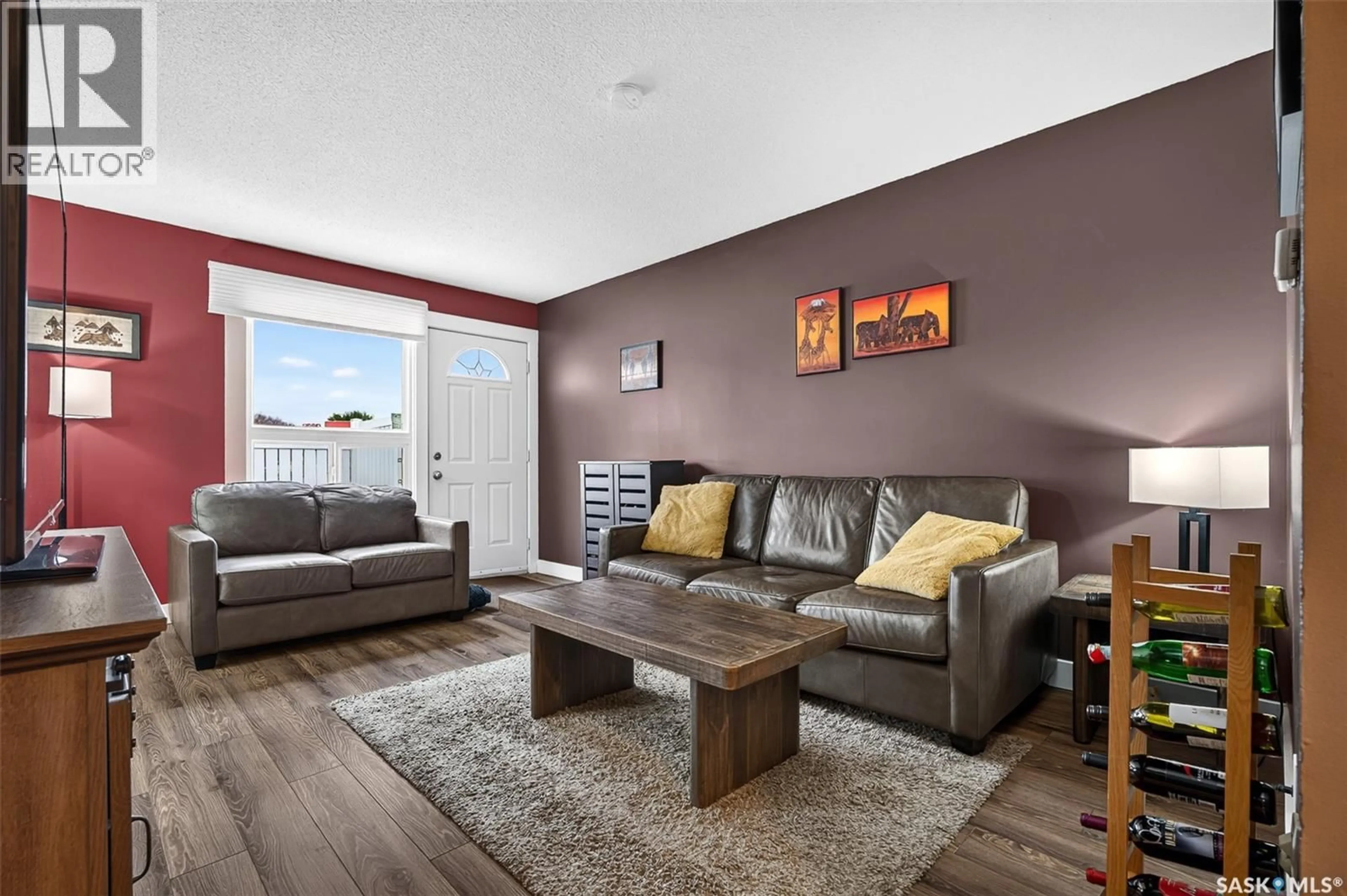 Living room with furniture, wood/laminate floor for 14 - 1292 GORDON ROAD, Moose Jaw Saskatchewan S6H3E5