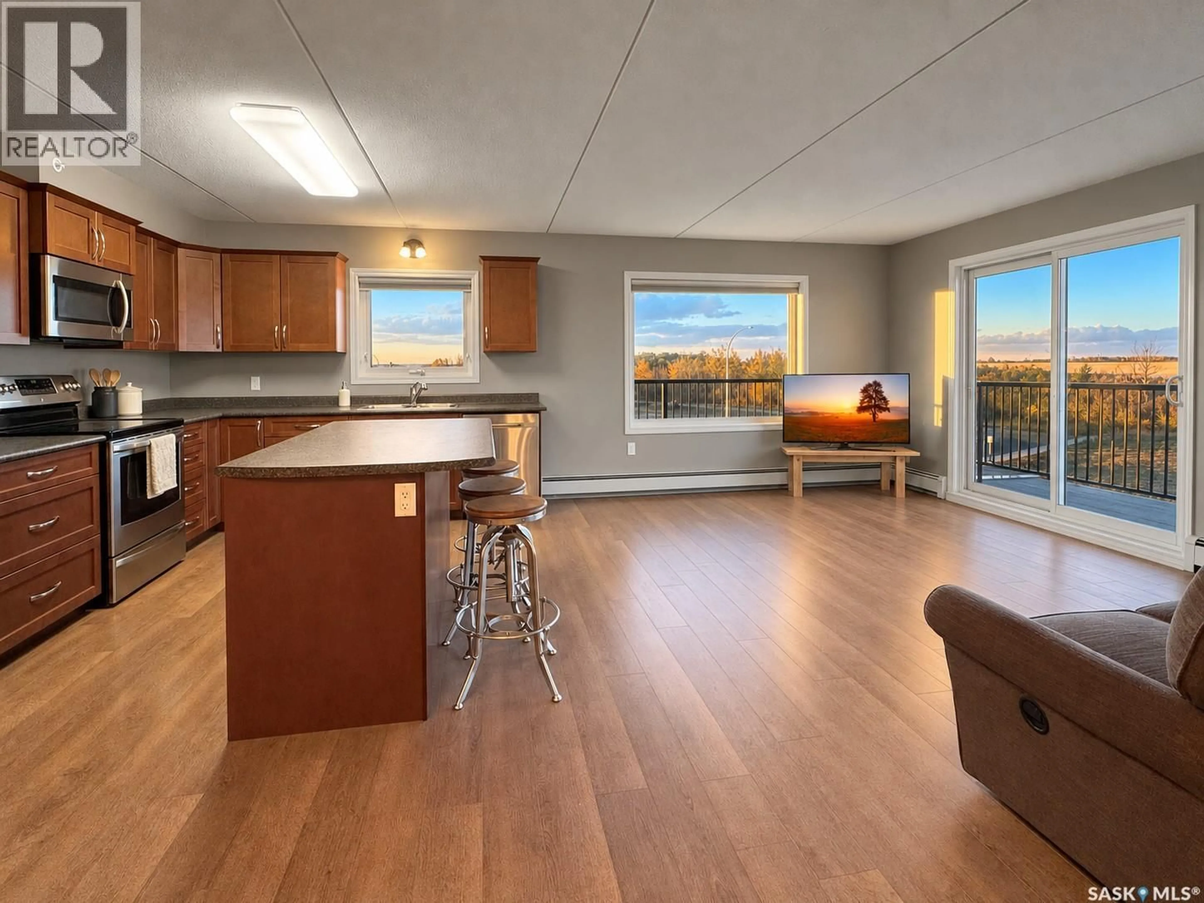 Open concept kitchen, wood/laminate floor for 308 - 2426 BUHLER AVENUE, North Battleford Saskatchewan S9A1R5