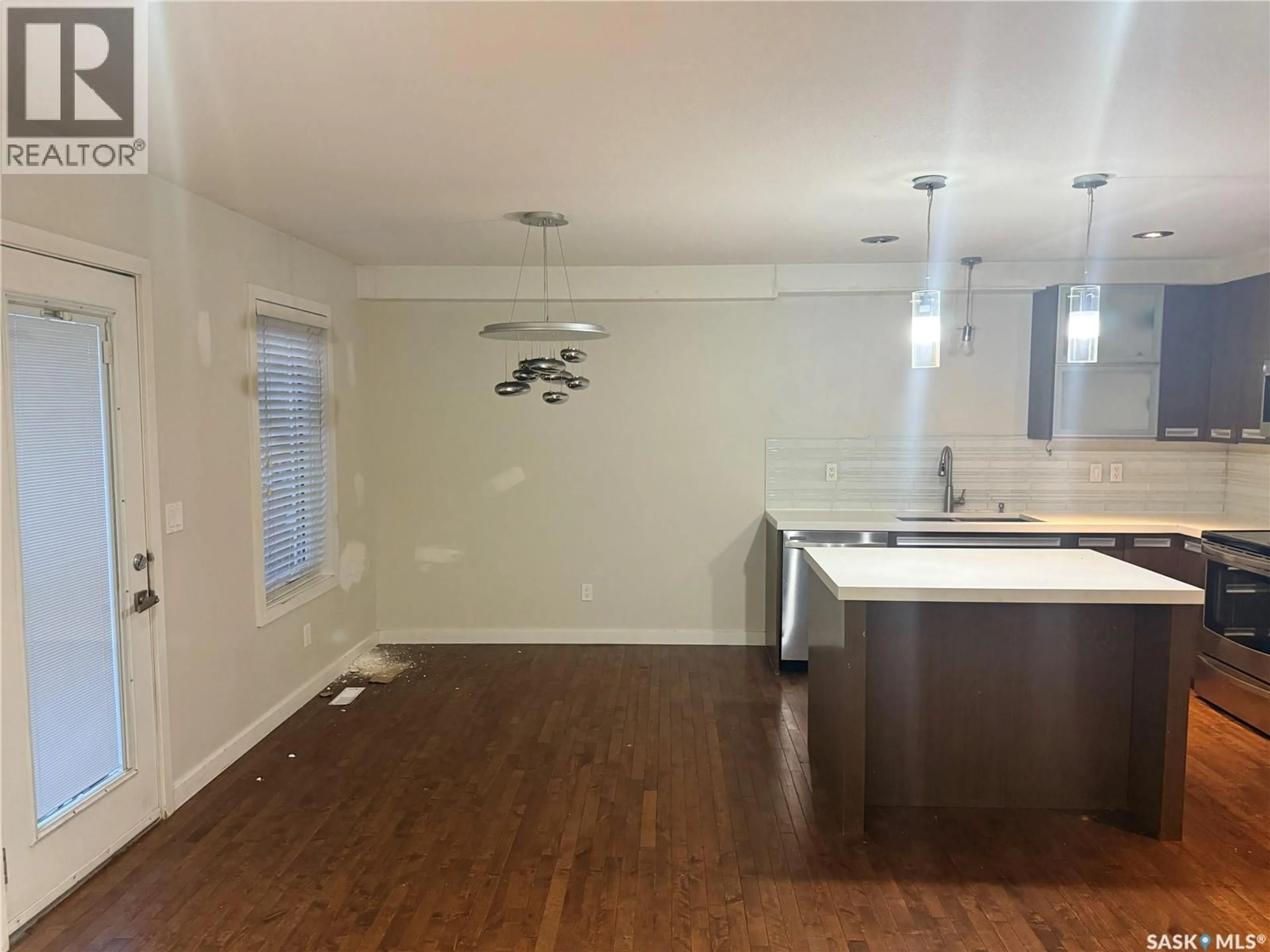 Open concept kitchen, wood/laminate floor for 1311 DENHAM CRESCENT, Saskatoon Saskatchewan S7R0B2