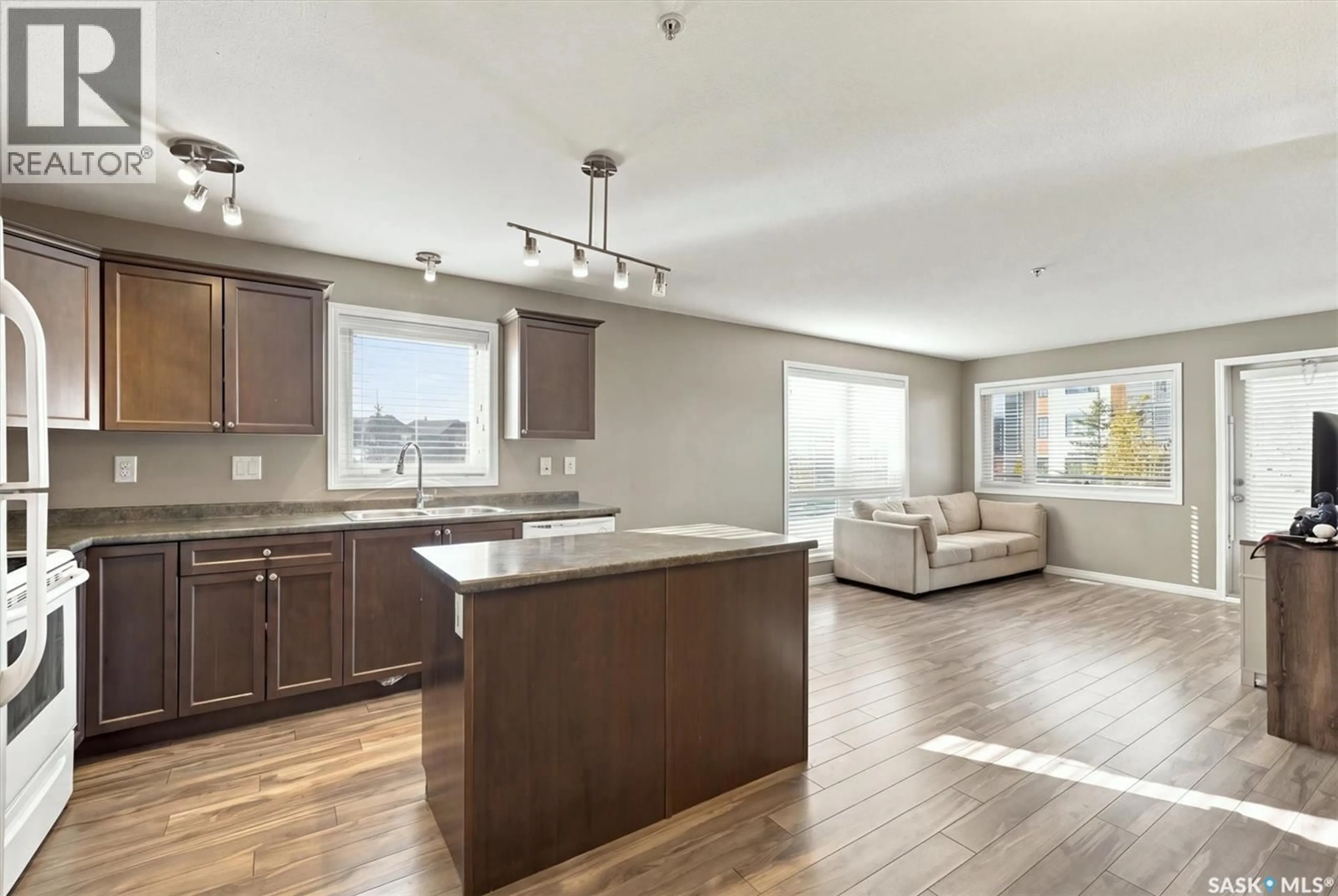 Open concept kitchen, wood/laminate floor for 110 - 5105 WILLIS CRESCENT, Saskatoon Saskatchewan S7T0N5
