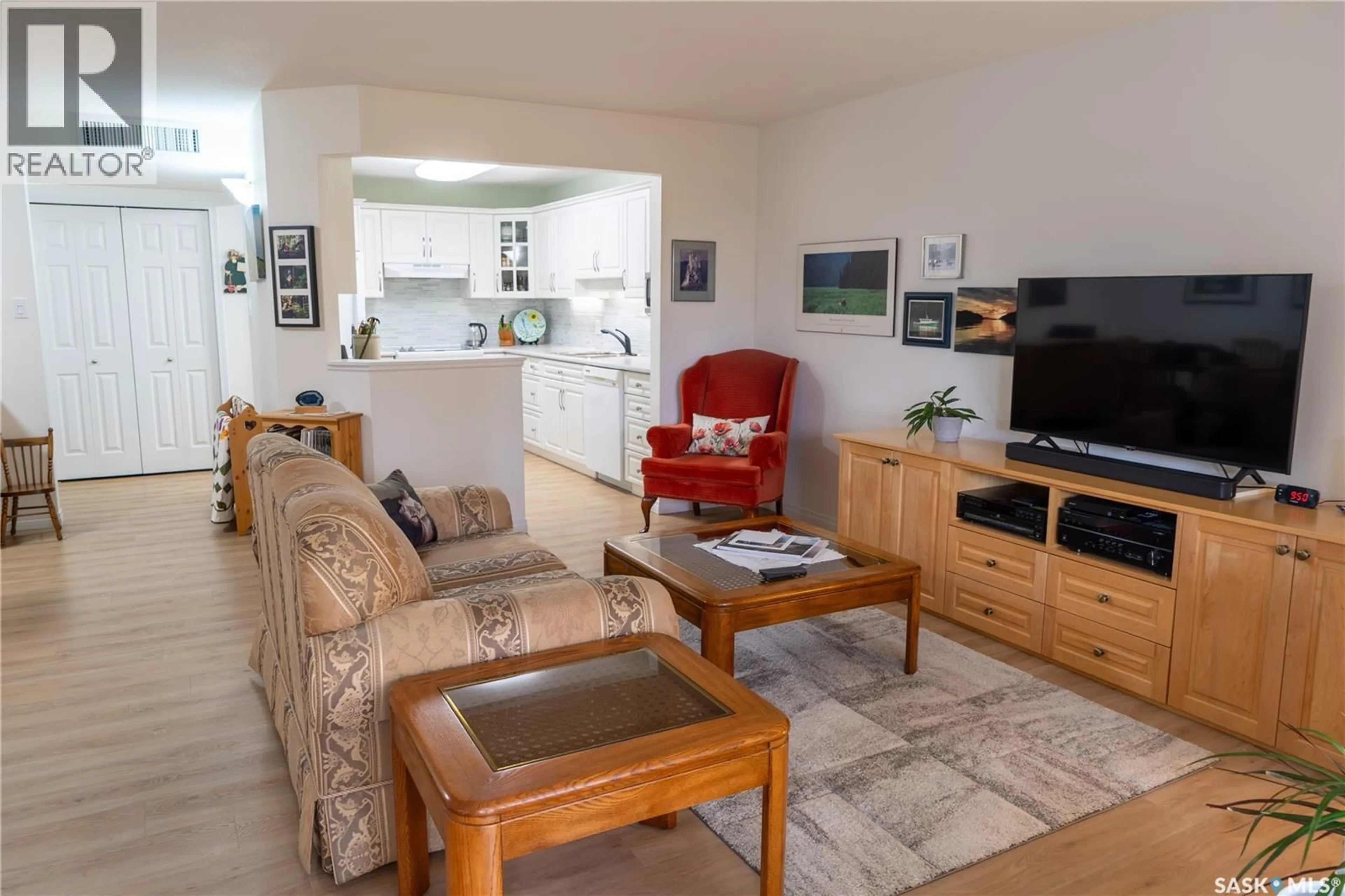 Living room with furniture, wood/laminate floor for 305 - 324 PINEHOUSE DRIVE, Saskatoon Saskatchewan S7K7Z4