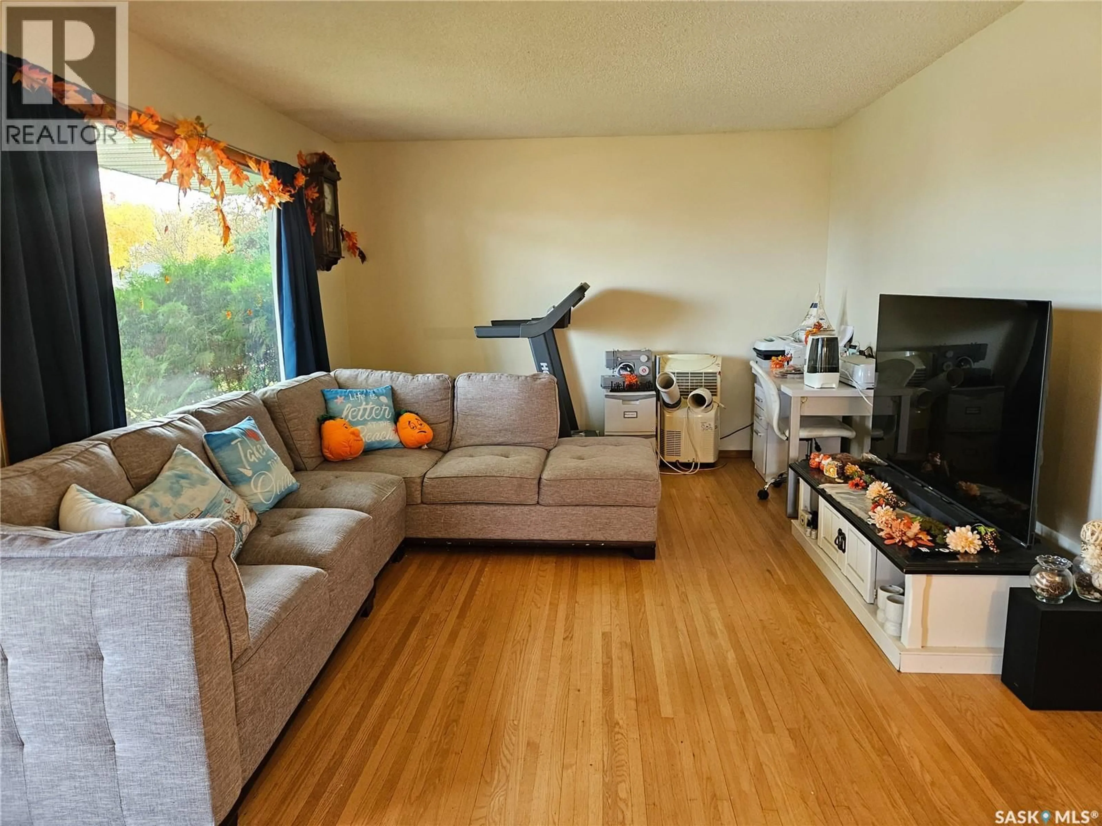 Living room with furniture, wood/laminate floor for 30 ALLEN DRIVE, Swift Current Saskatchewan S9H3A1