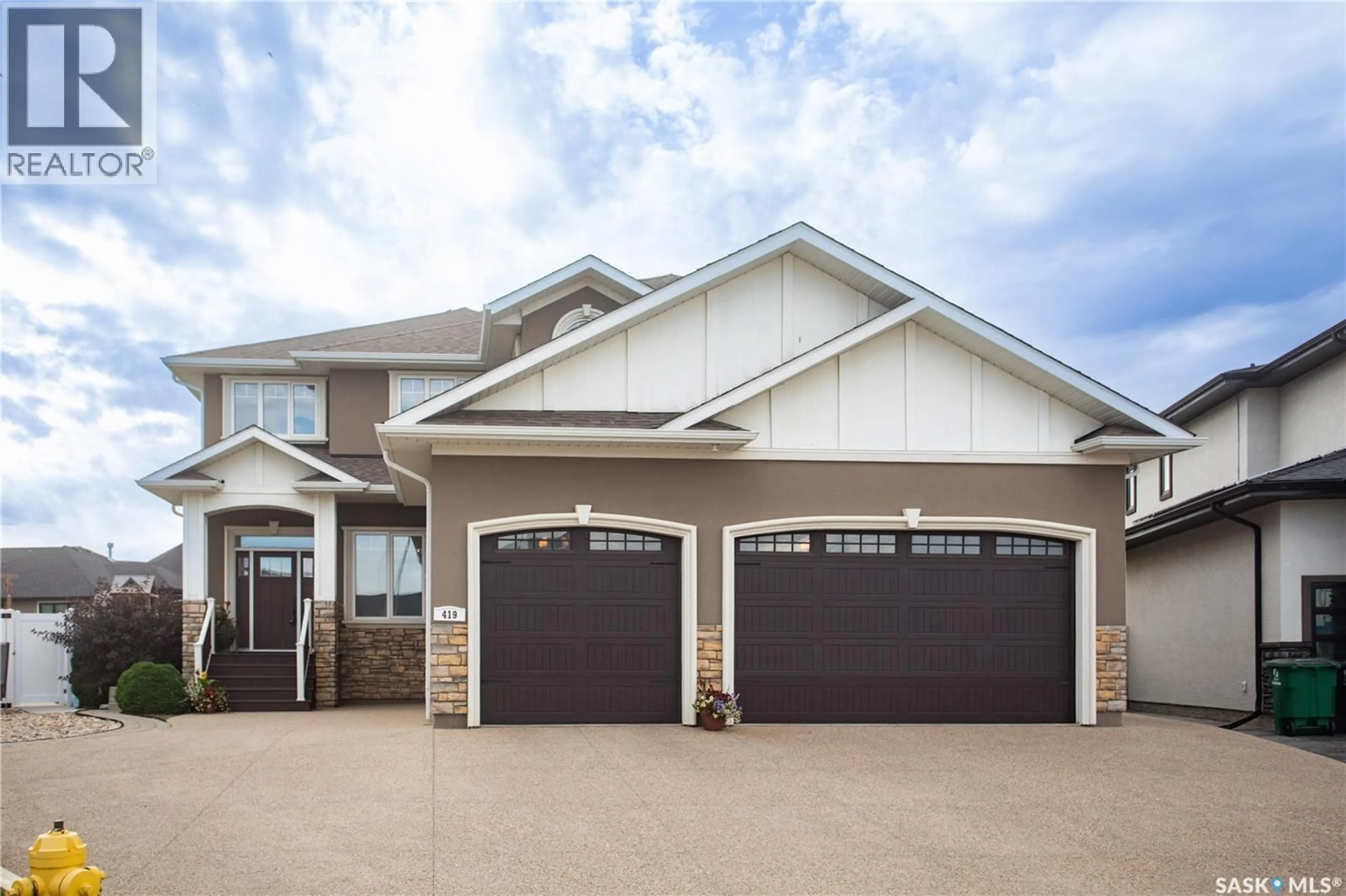 Home with vinyl exterior material, street for 419 SALLOUM BAY, Saskatoon Saskatchewan S7W0N1