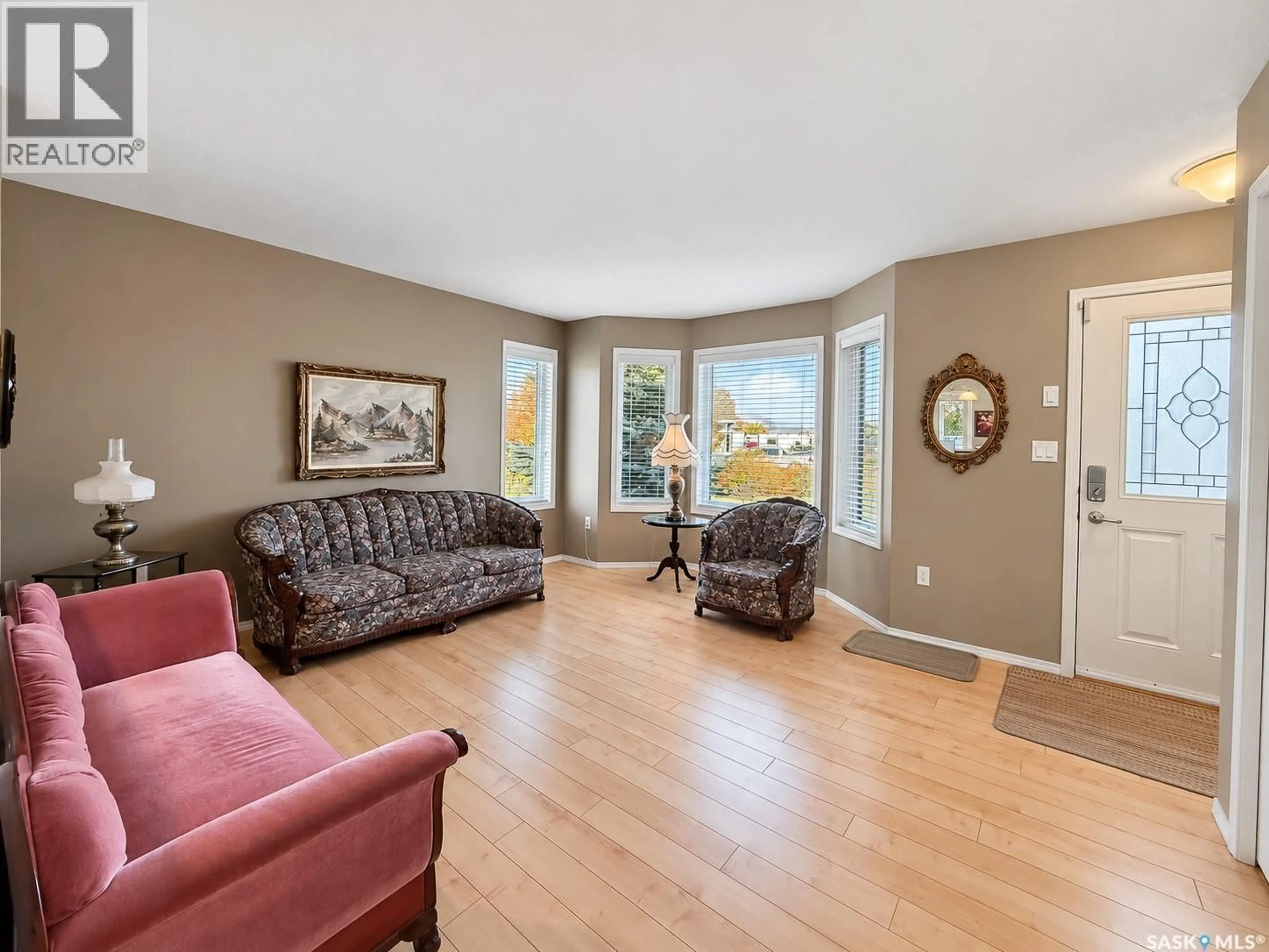 Living room with furniture, wood/laminate floor for C - 10922 AMOS DRIVE, North Battleford Saskatchewan S9A1B6