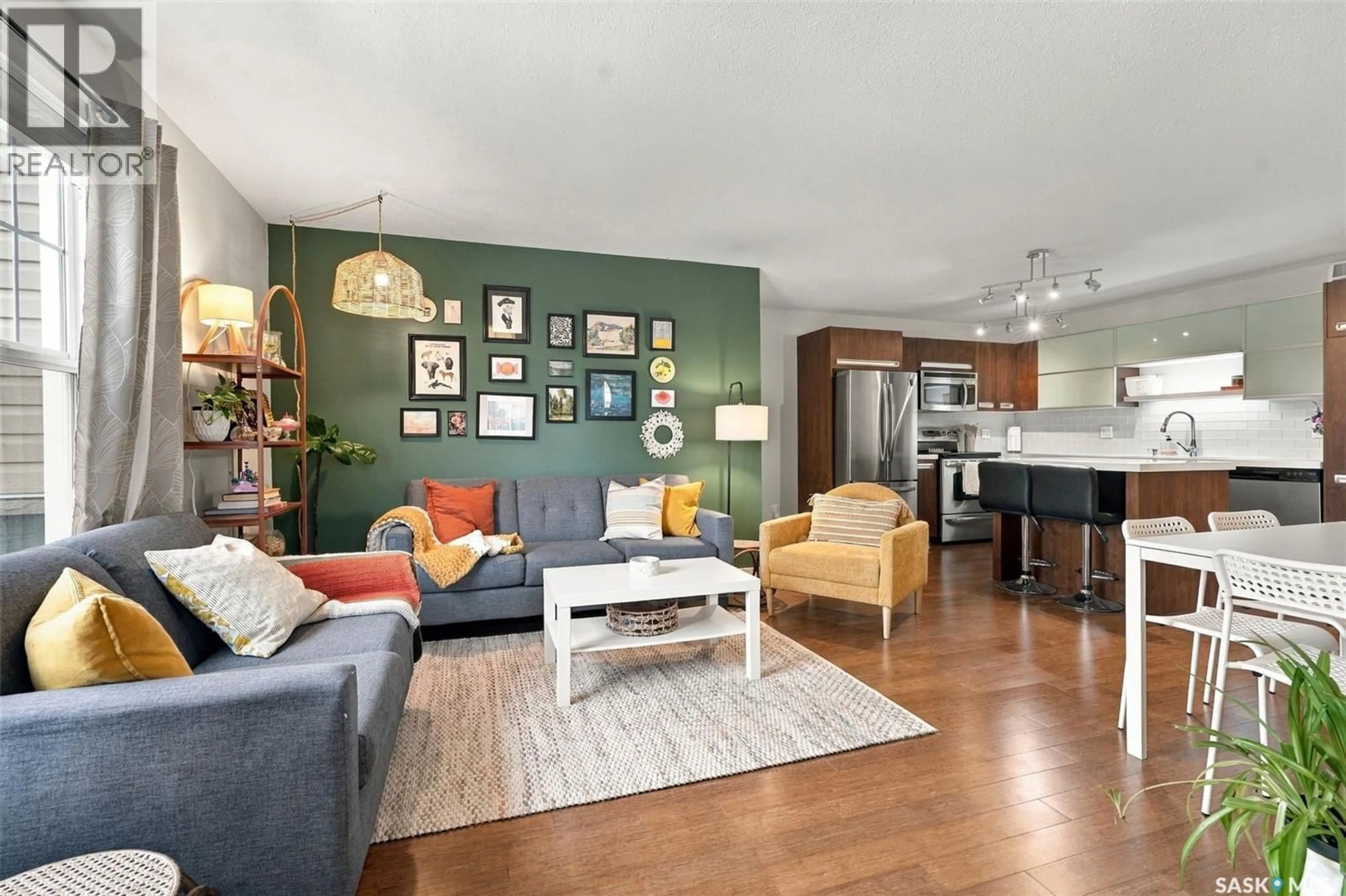 Living room with furniture, wood/laminate floor for 1015 - 211 PATRICK CRESCENT, Saskatoon Saskatchewan S7W0M2