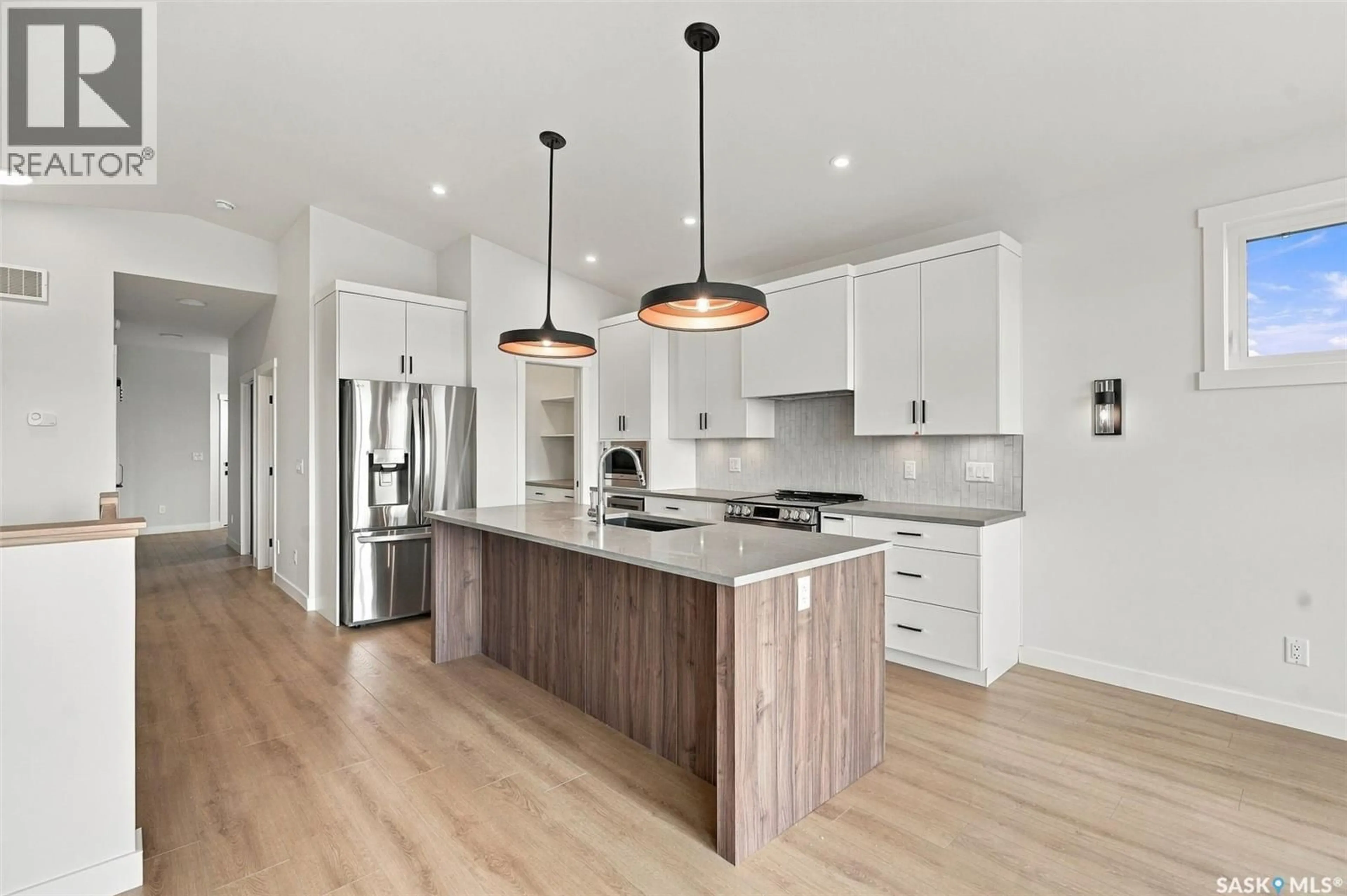 Open concept kitchen, wood/laminate floor for 151 NAZARALI WAY, Saskatoon Saskatchewan S7V1P6
