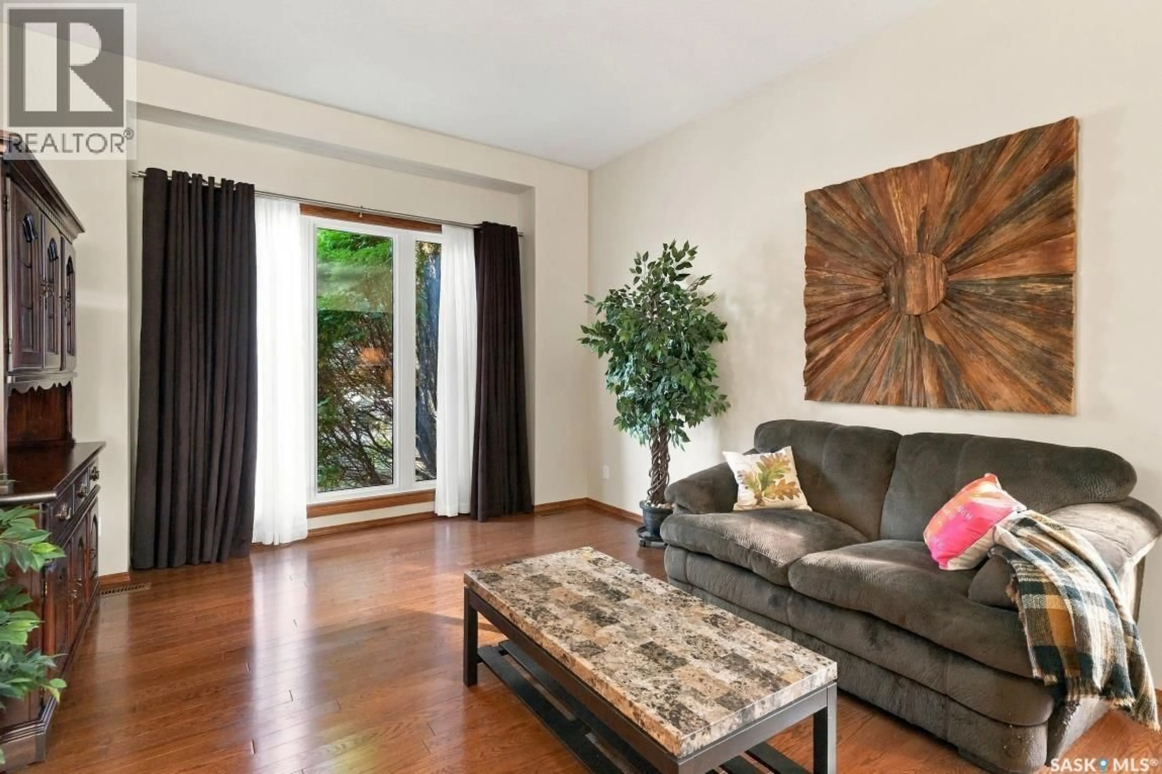 Living room with furniture, wood/laminate floor for 410 BRONSON CRESCENT, Saskatoon Saskatchewan S7J5E2